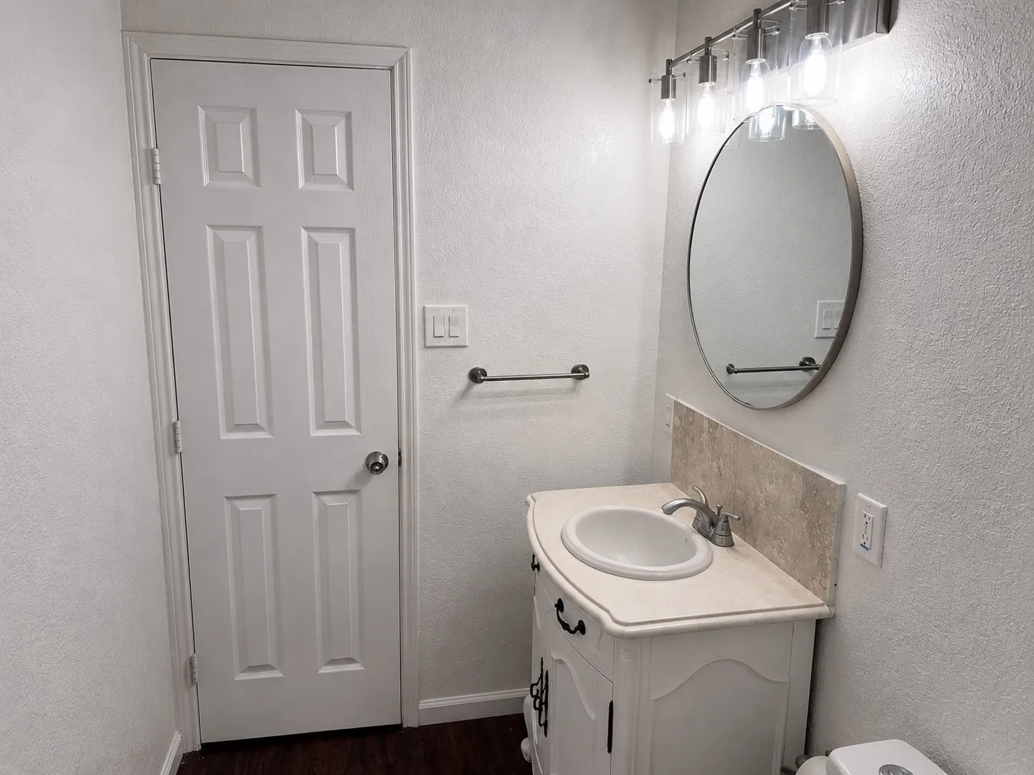 White paneled door with a chrome doorknob