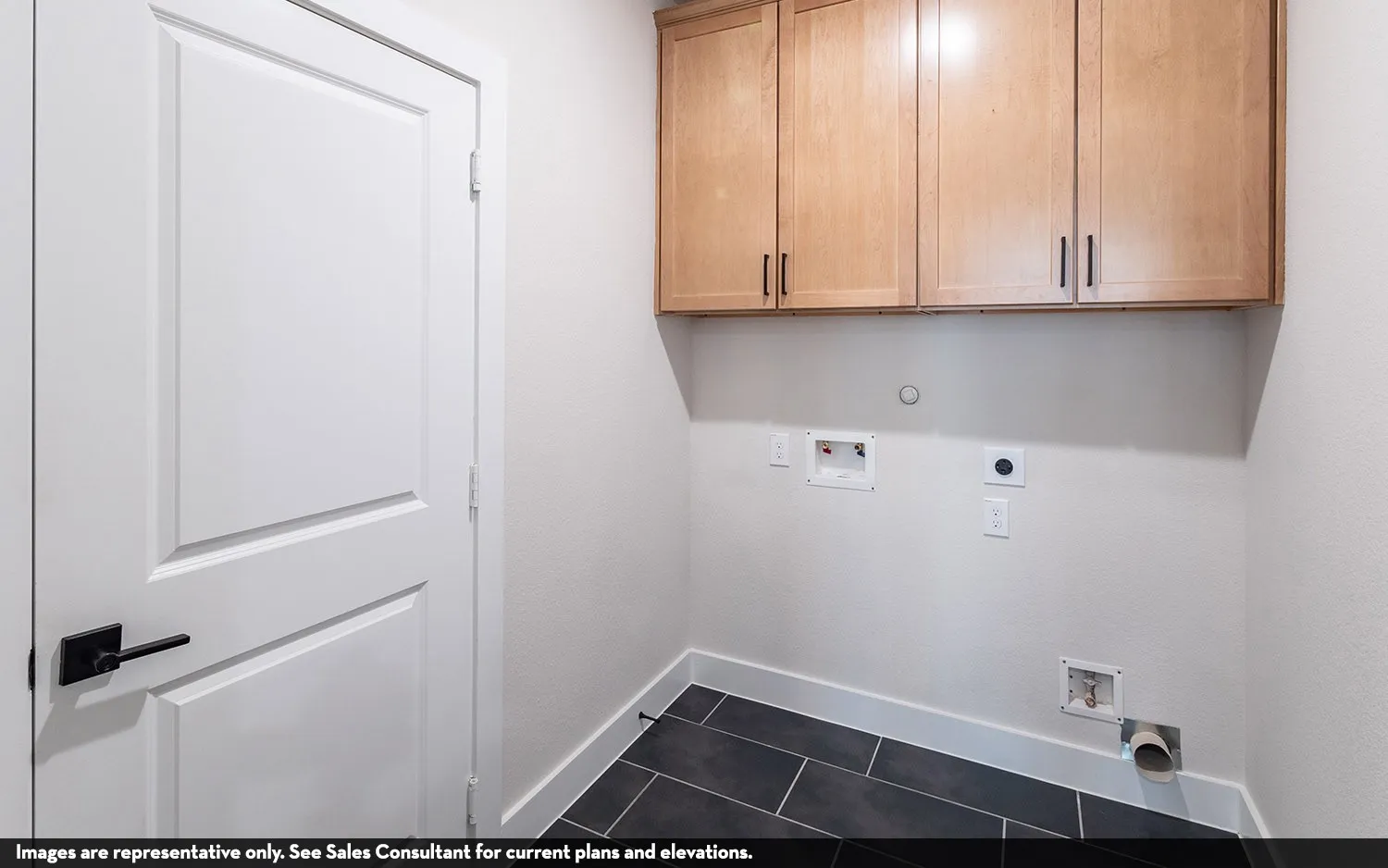 Light wood-finish cabinetry with matte black pulls