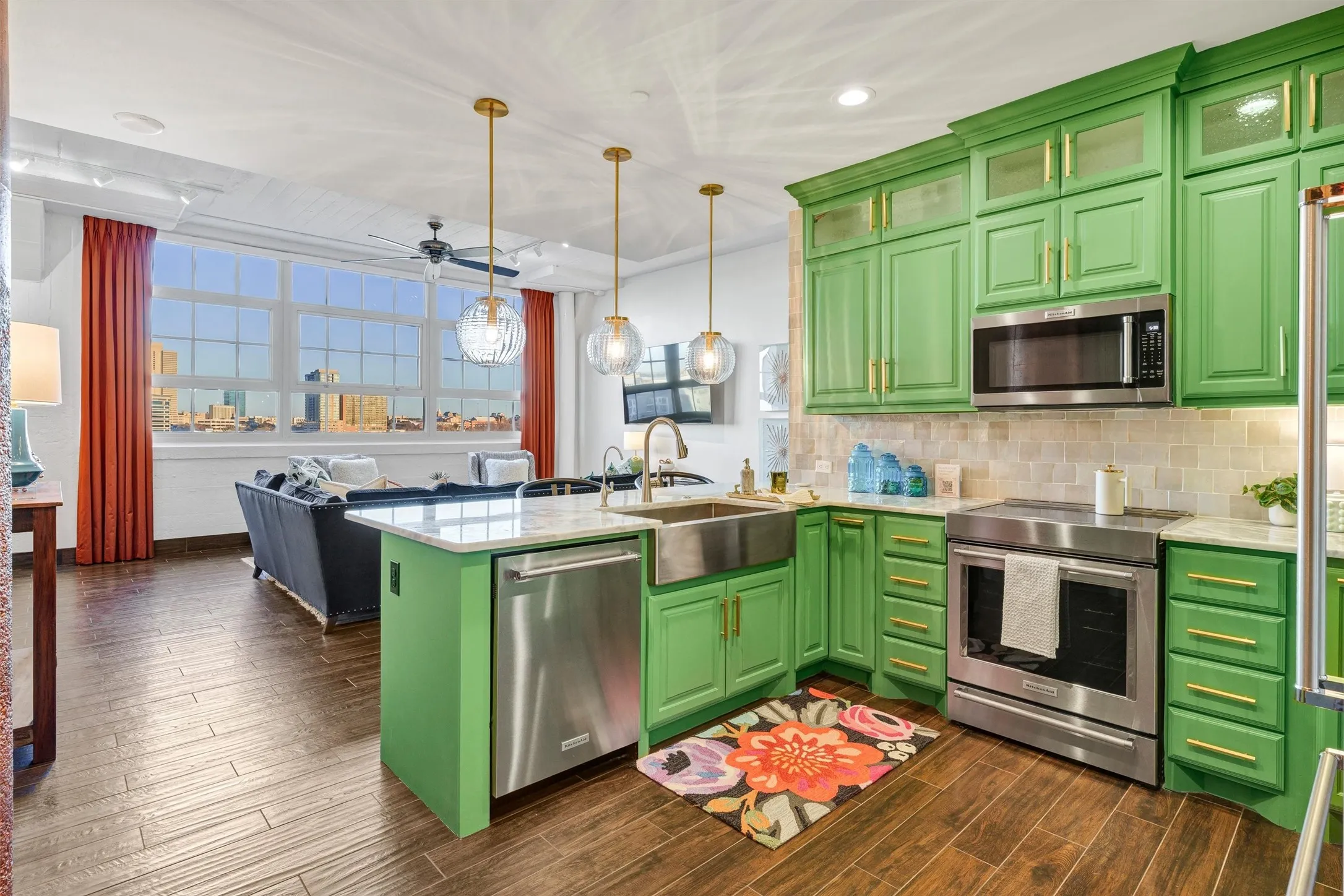Expansive, sun-filled open layout capturing the full line of sight from the gourmet kitchen through to the city skyline. Features a large island with an undermount farmhouse sink, integrated dishwasher, and statement pendant lighting overlooking the main living area.