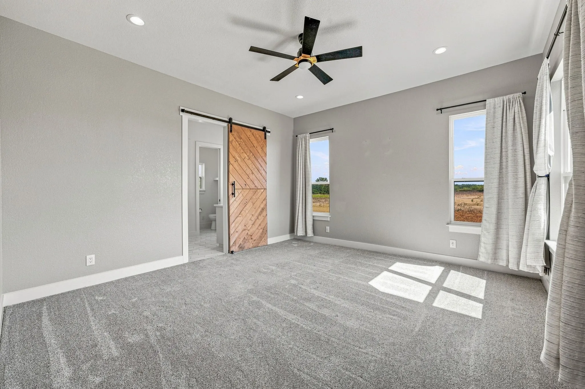 Recessed lighting, ceiling fan, and carpeted flooring