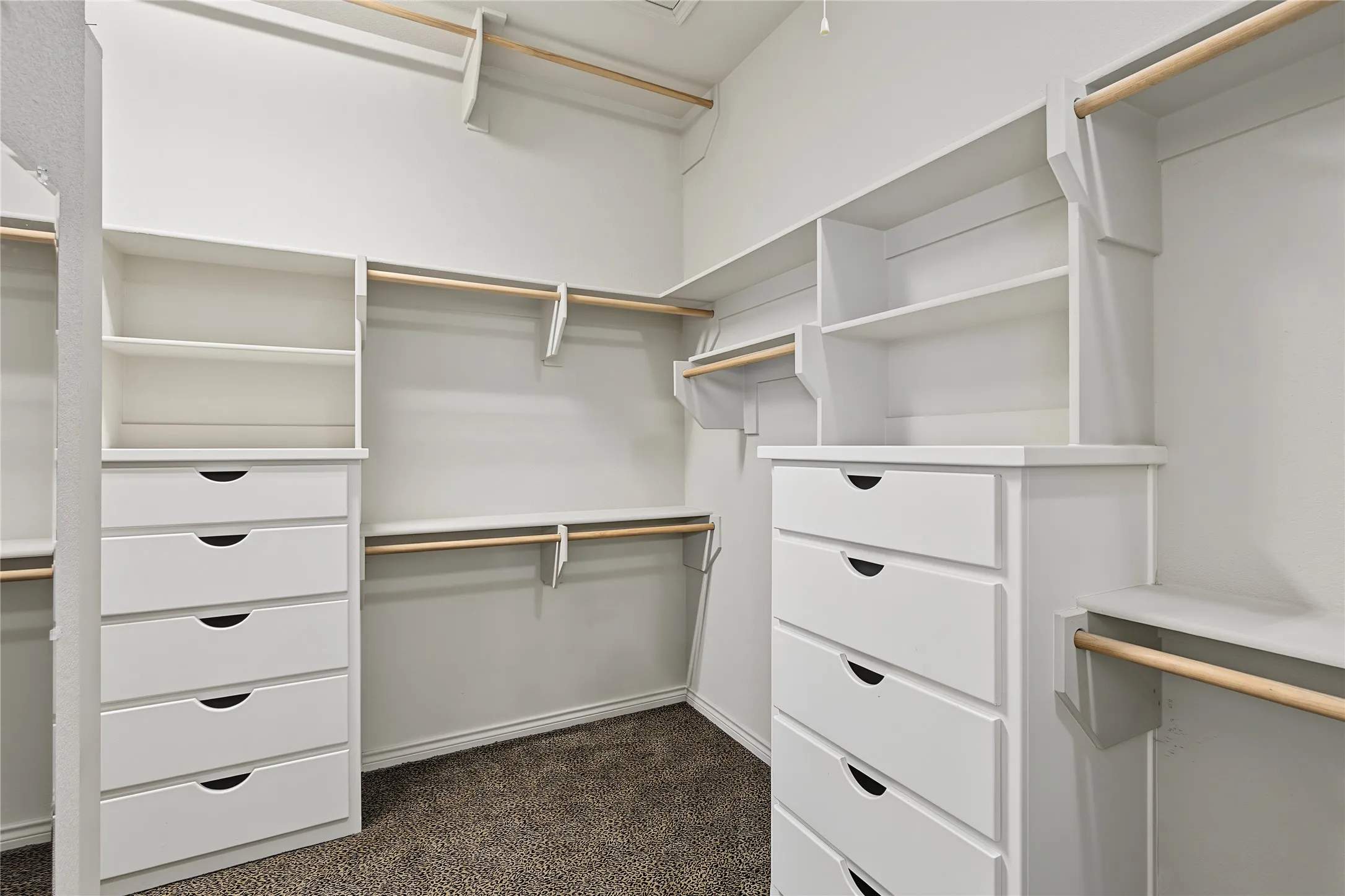 Primary Closet with Chest of Drawers and triple rods for seasonal clothes.