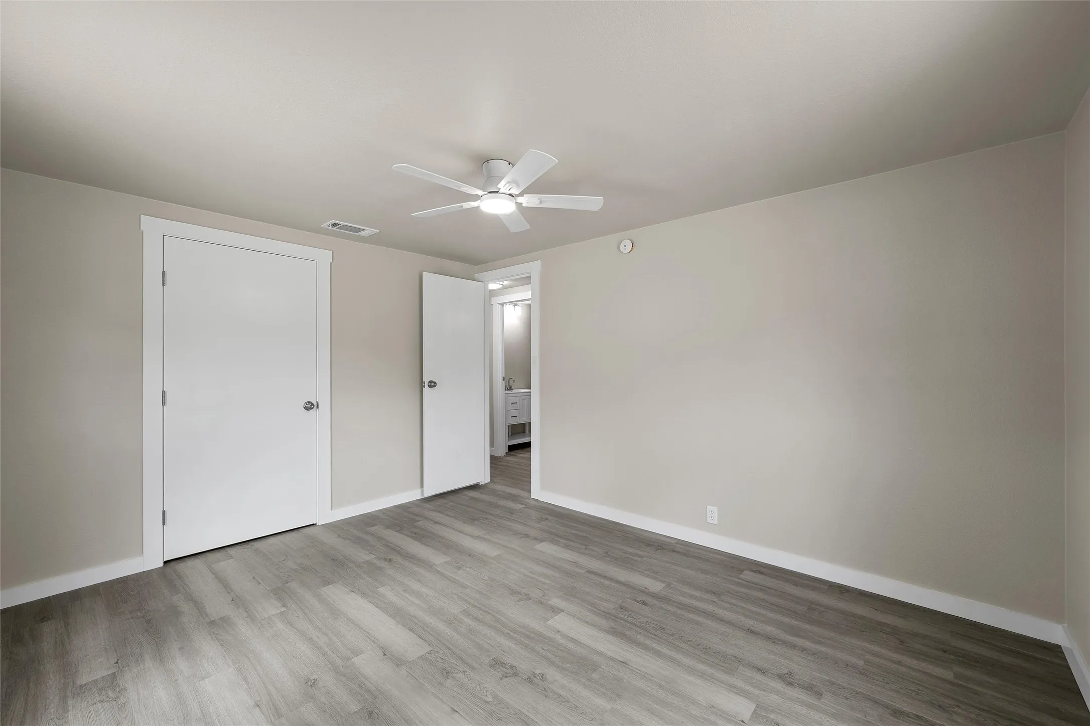 Wood-finish flooring with light neutral wall tones
