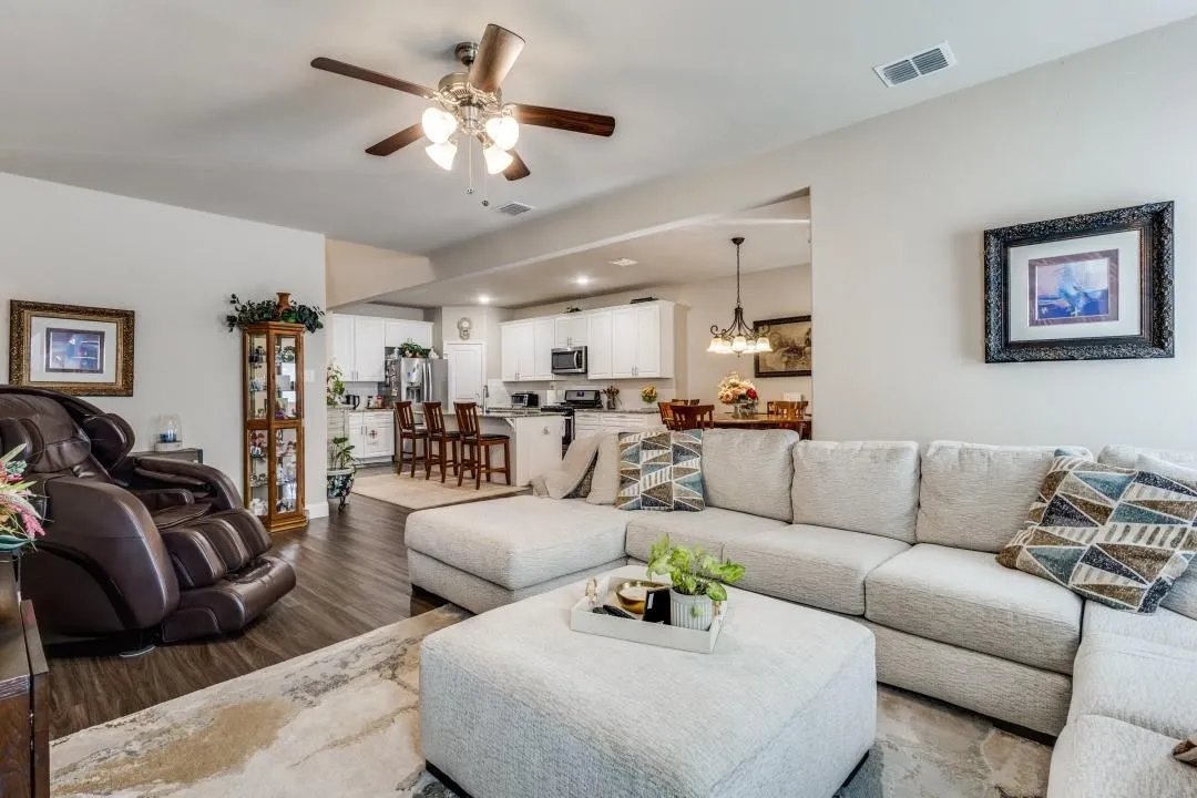 Open-concept living space with dark wood-finish flooring