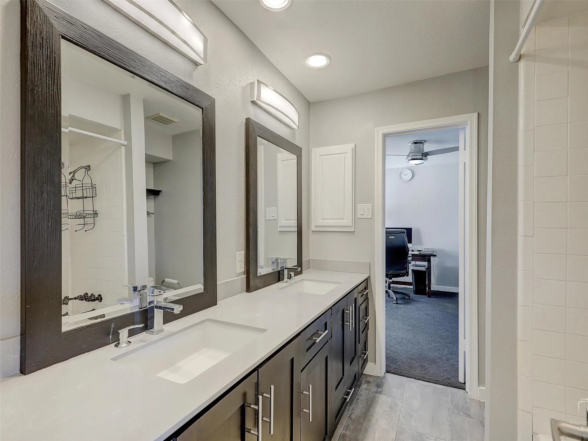 Bathroom featuring oversized vanity, ceiling fan, double sink, and tile flooring