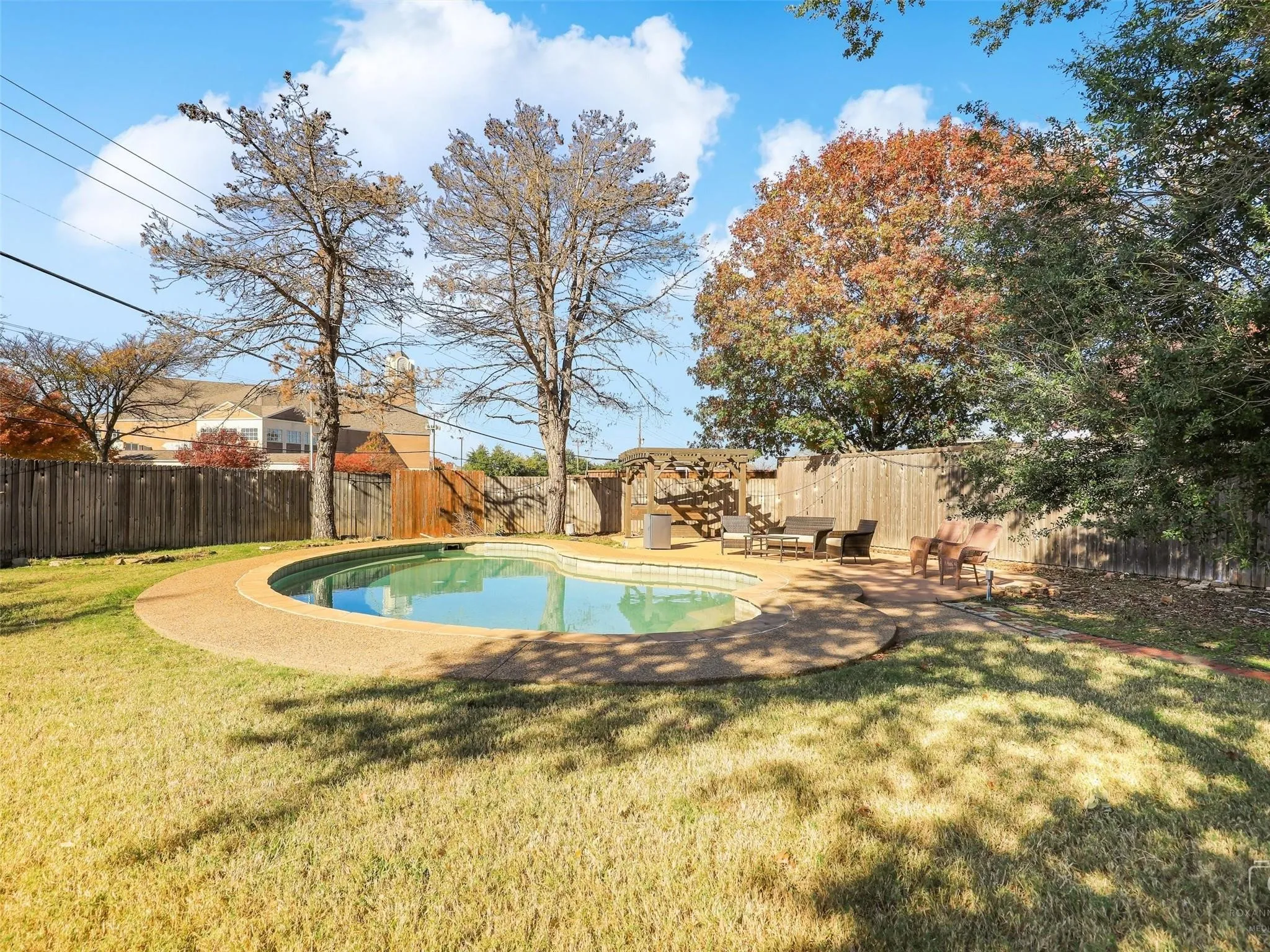 View of swimming pool with a patio and a lawn