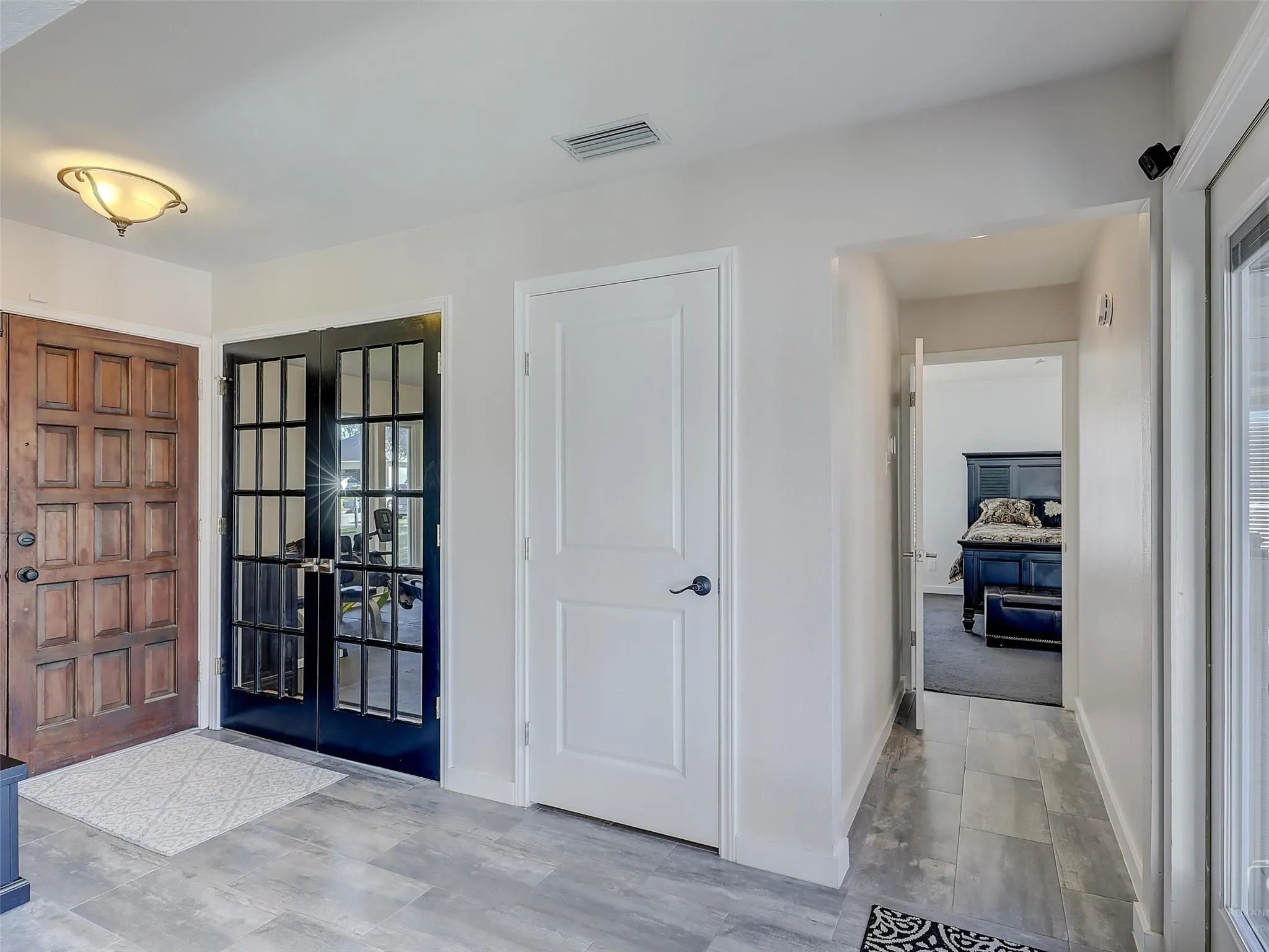 Entrance foyer featuring french doors and carpet