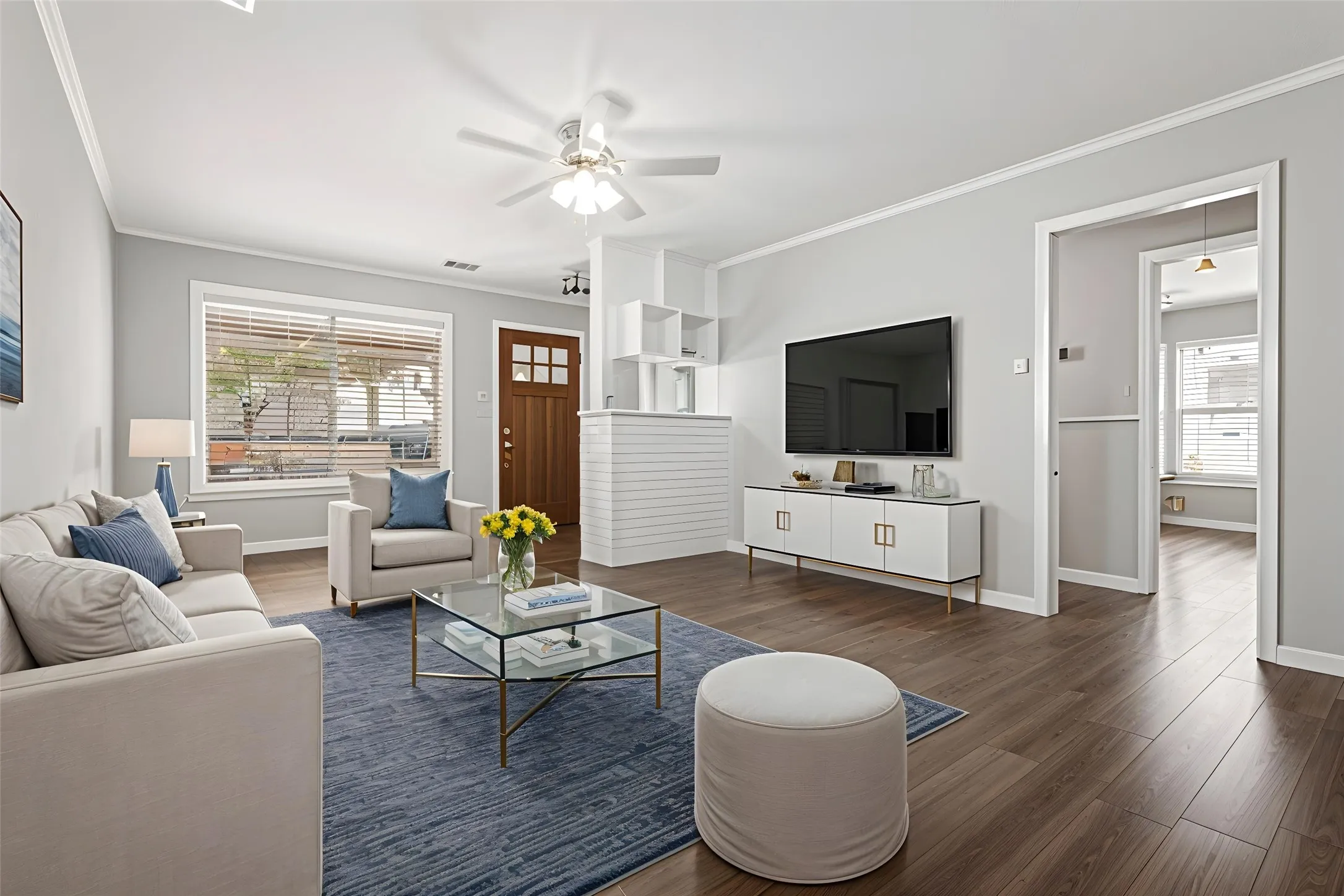 Recessed lighting, wood-finish flooring, ceiling fan, crown molding, and a solid wood front door with glass inserts