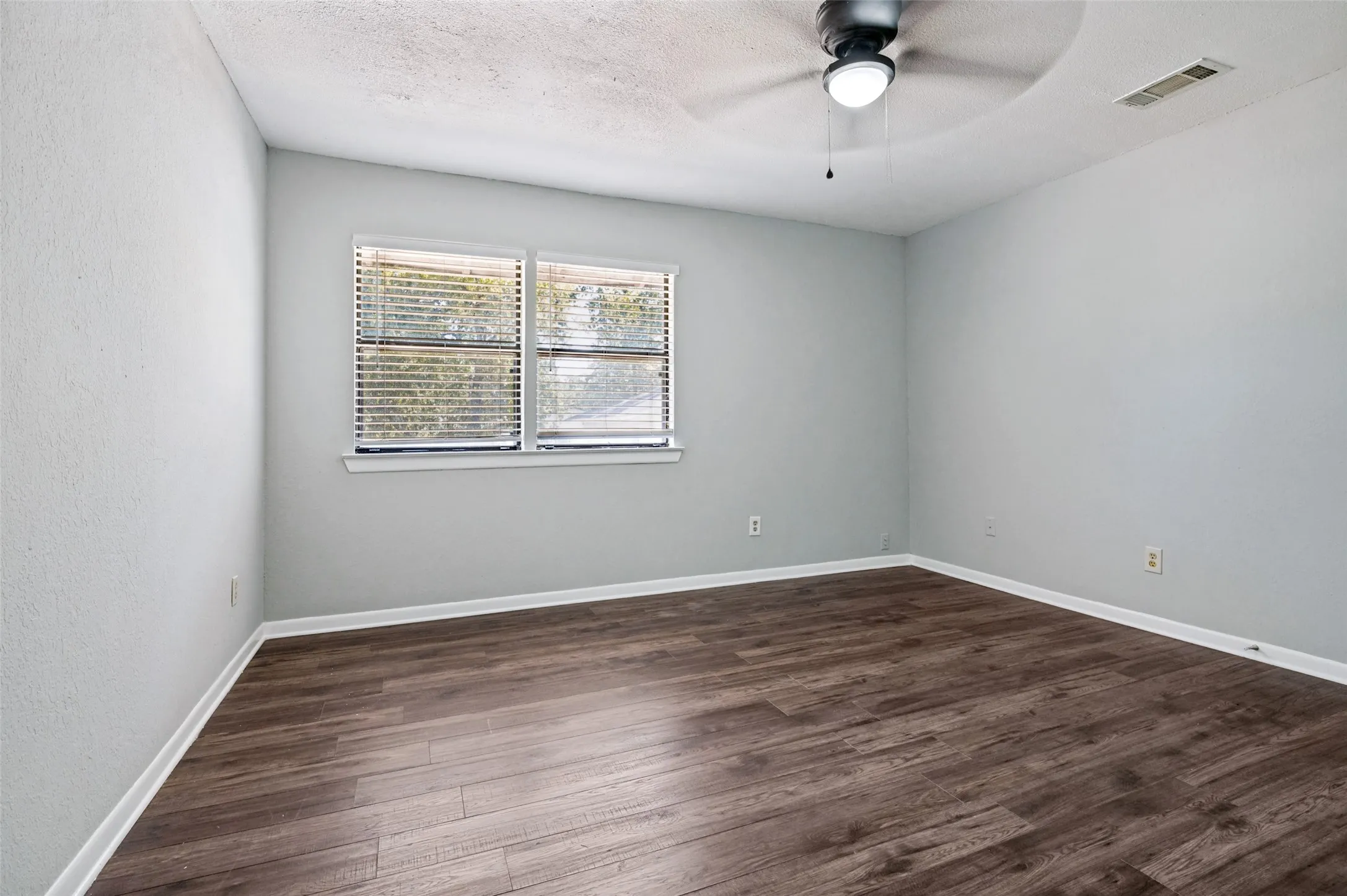 Neutral-toned walls complement wood-finish flooring