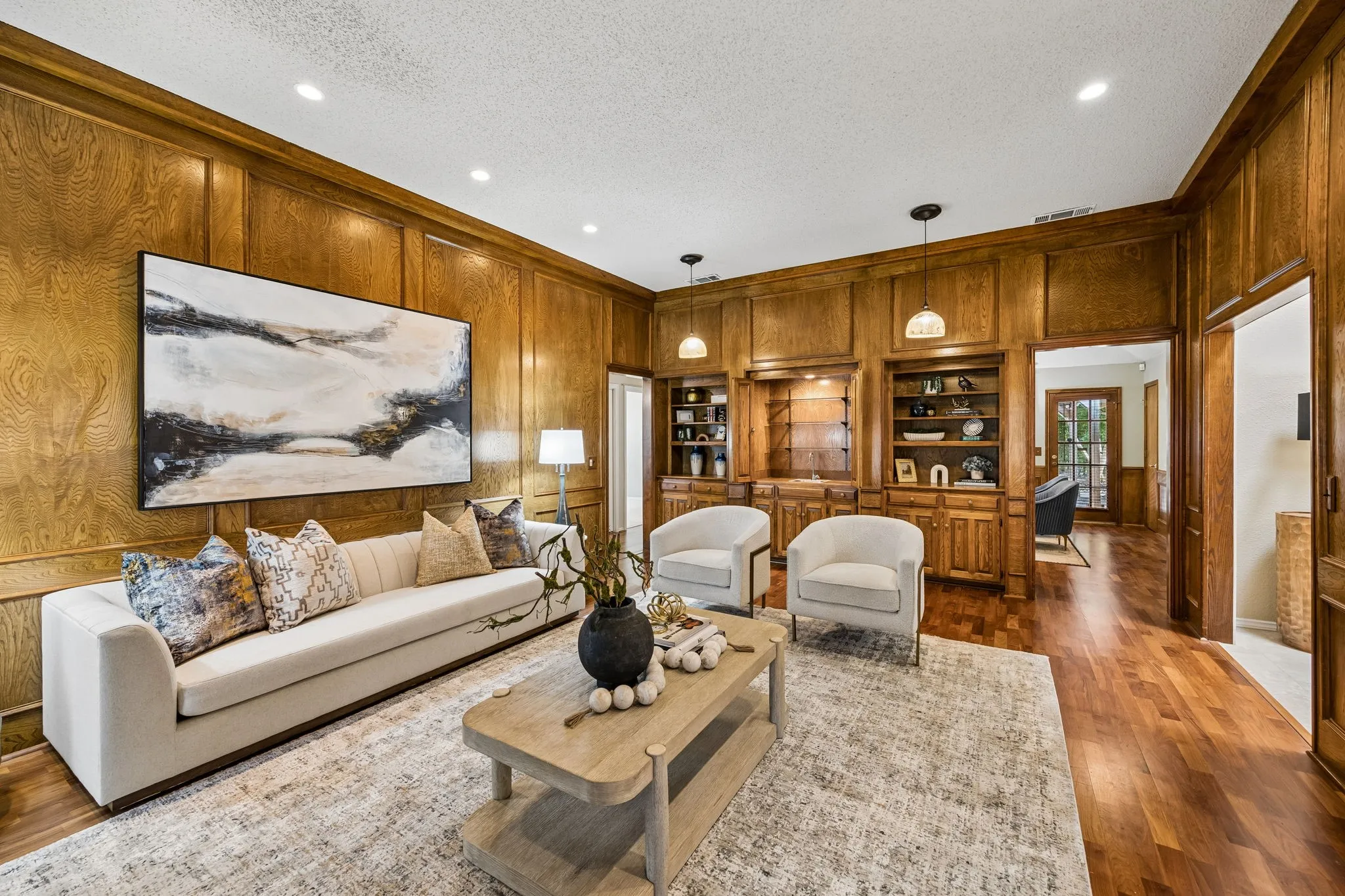 The living room features a wet bar and storage shelves.