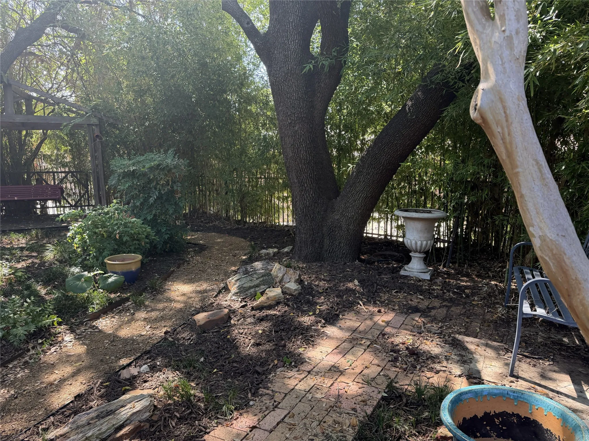 The backyard features mature trees and several garden spots to saunter through and take in the season colors.