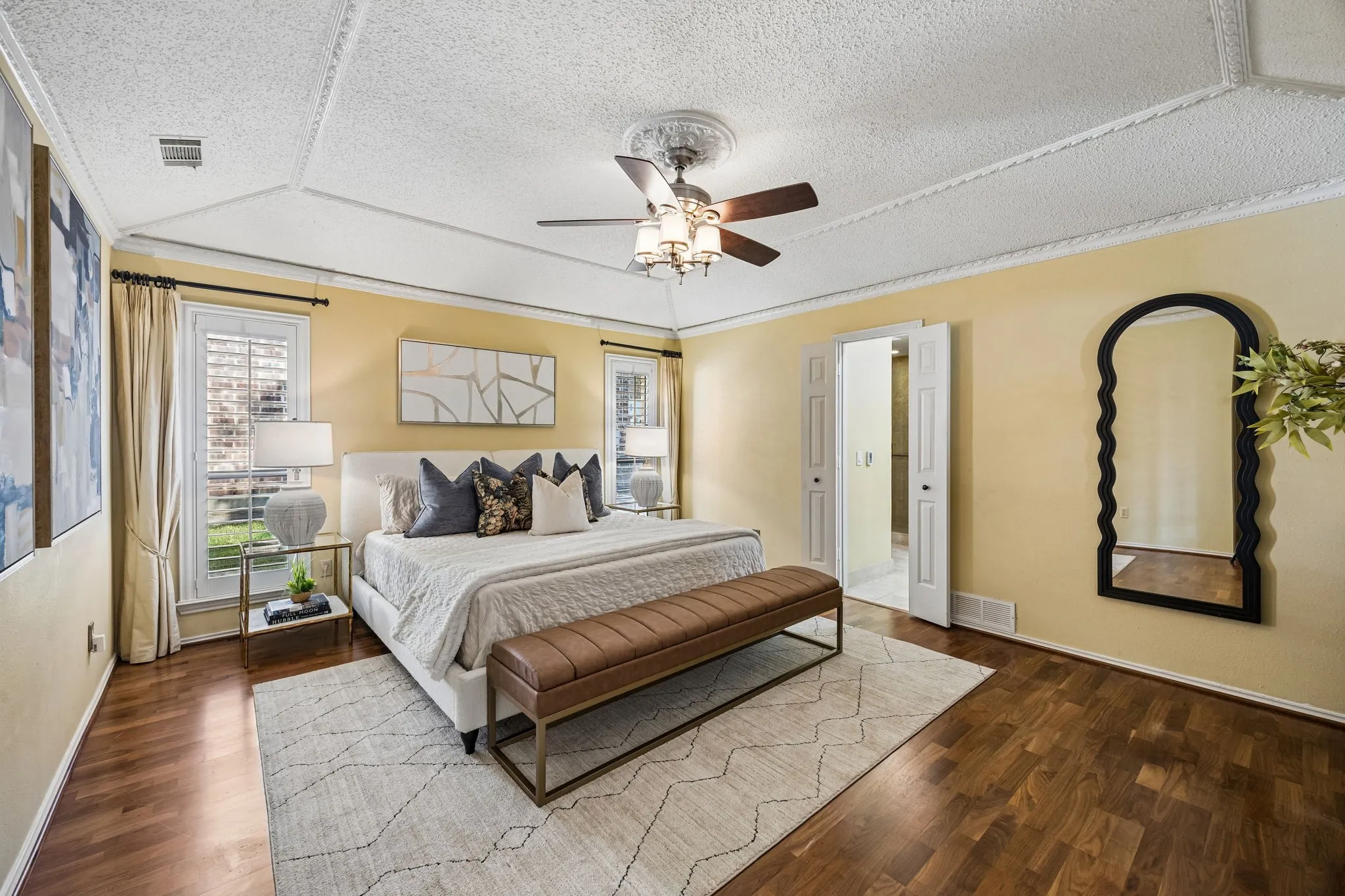 The primary bedroom has plenty of room for a king-sized bed and features laminate wood flooring.