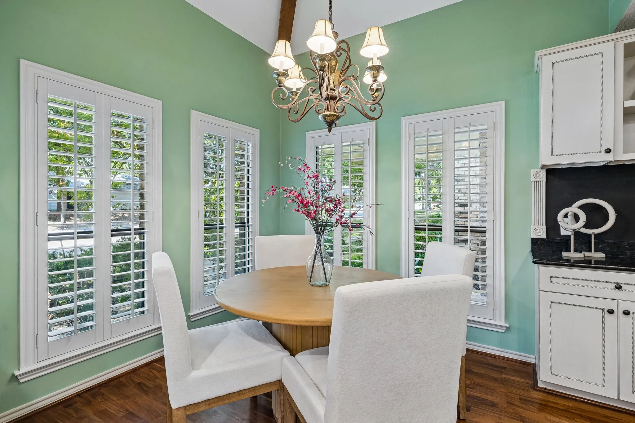 The breakfast area is integrated into the kitchen and has views of the front gardens.  A built-in coffee-bar features a magnetic backsplash to post family activity calendars and photos.