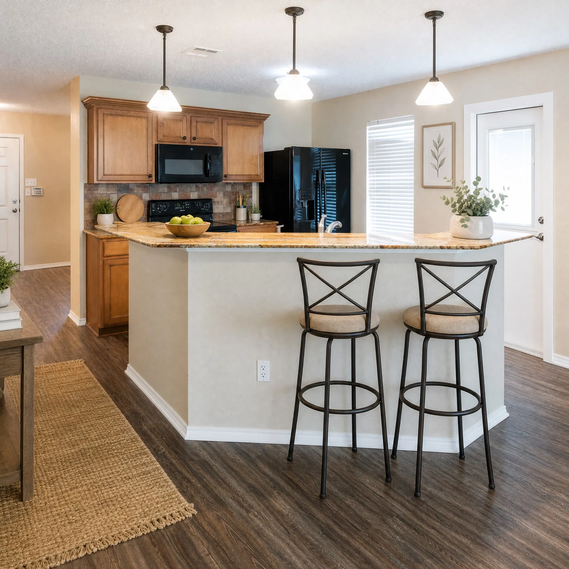 Open concept kitchen with bar seating and access to the backyard
