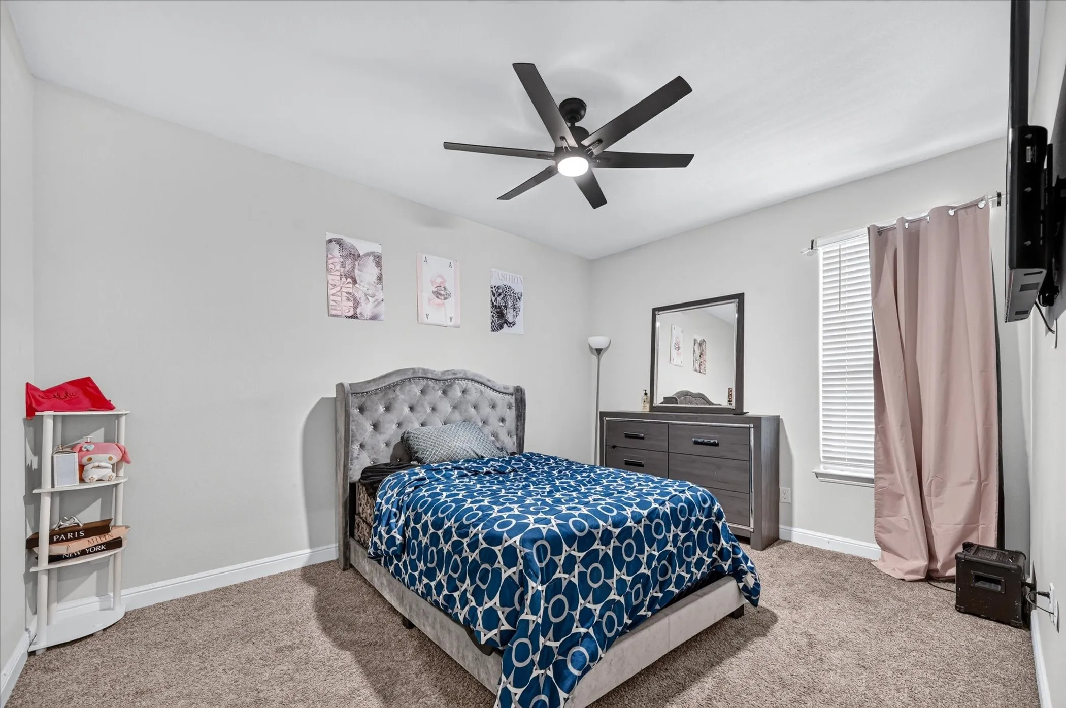 Wall-to-wall carpeting and a ceiling fan with integrated lighting