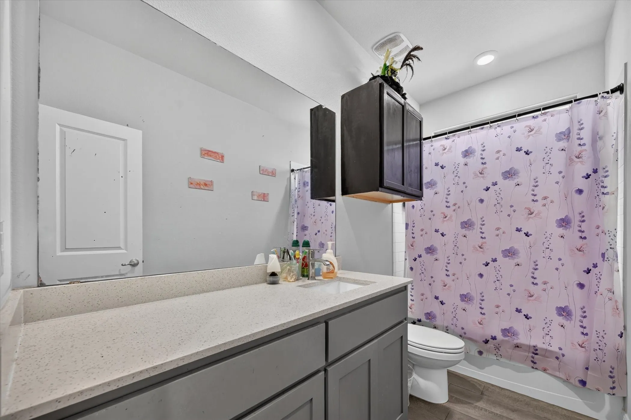 Vanity featuring a single rectangular sink and light-toned countertop