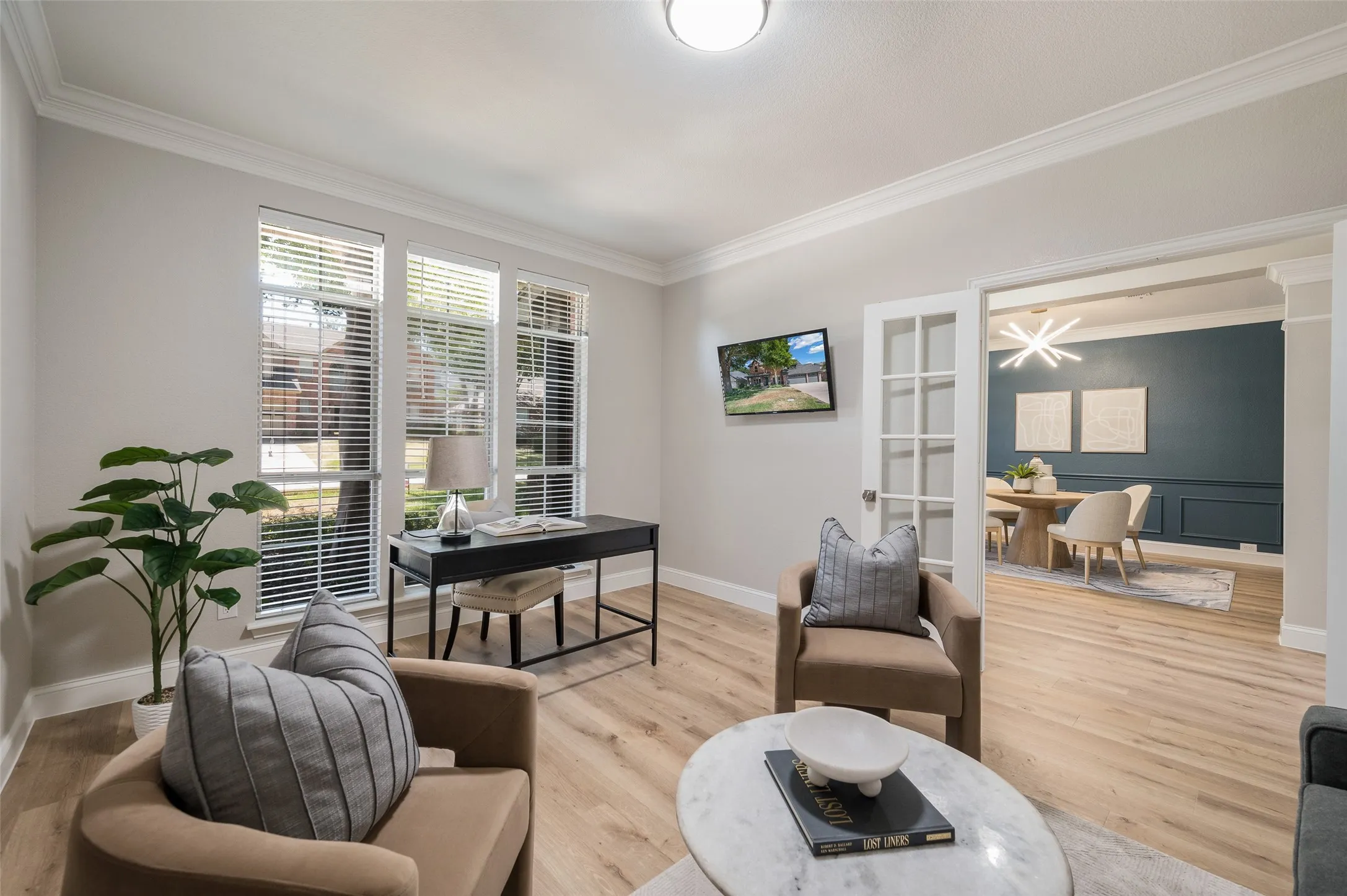 Roomy office with beautiful crown moulding and French doors.
