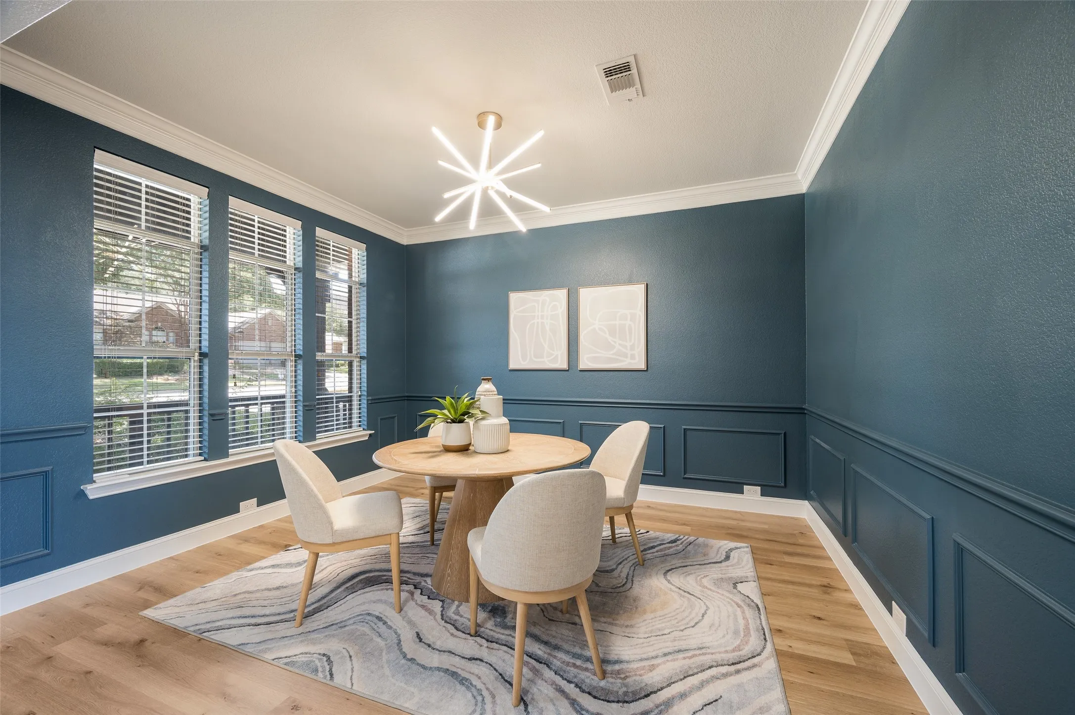 Beautiful updated lighting in dining room that looks out to front sitting porch.