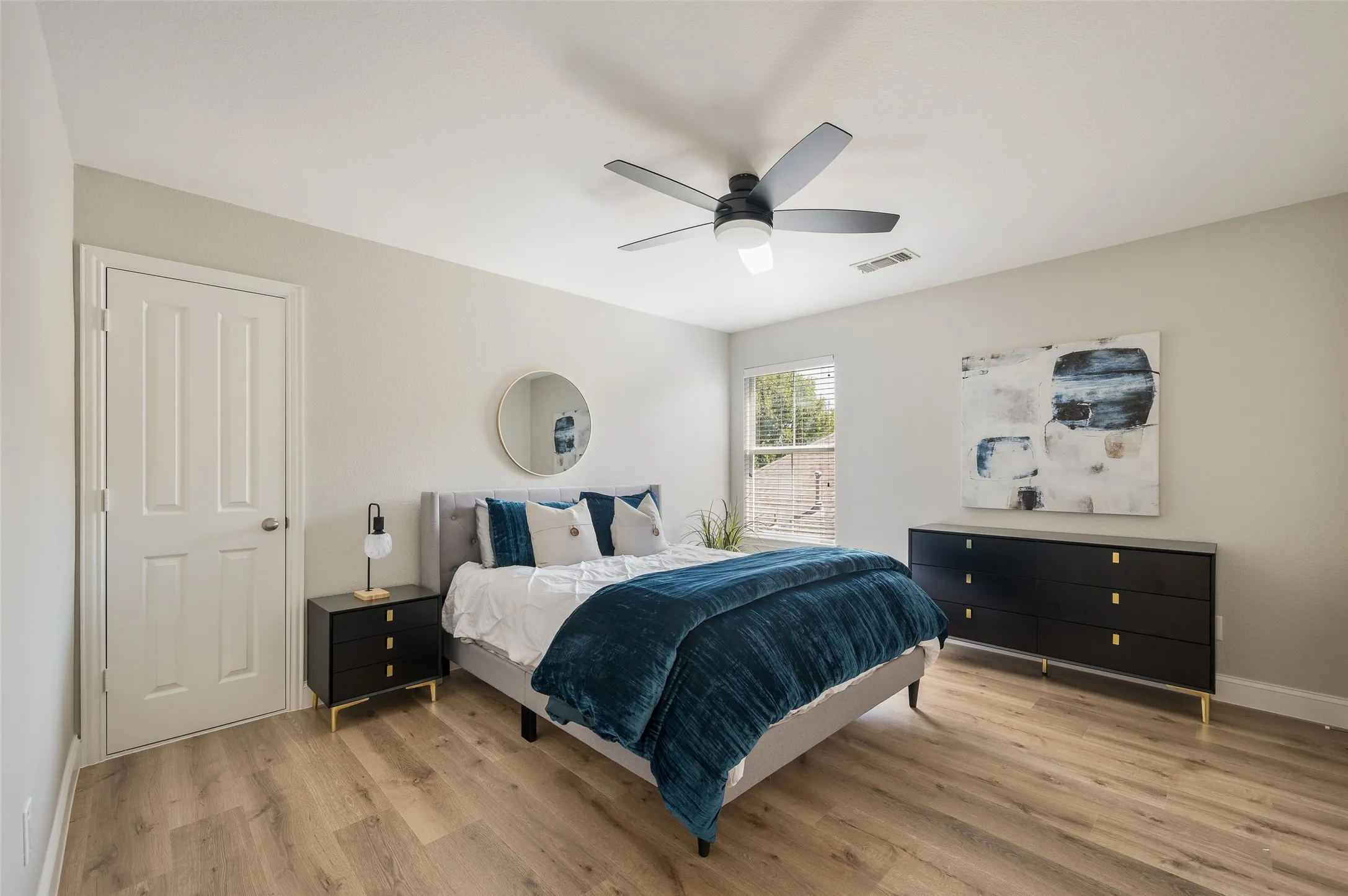 Roomy 2nd bedroom with updated flooring, fan and fresh paint.