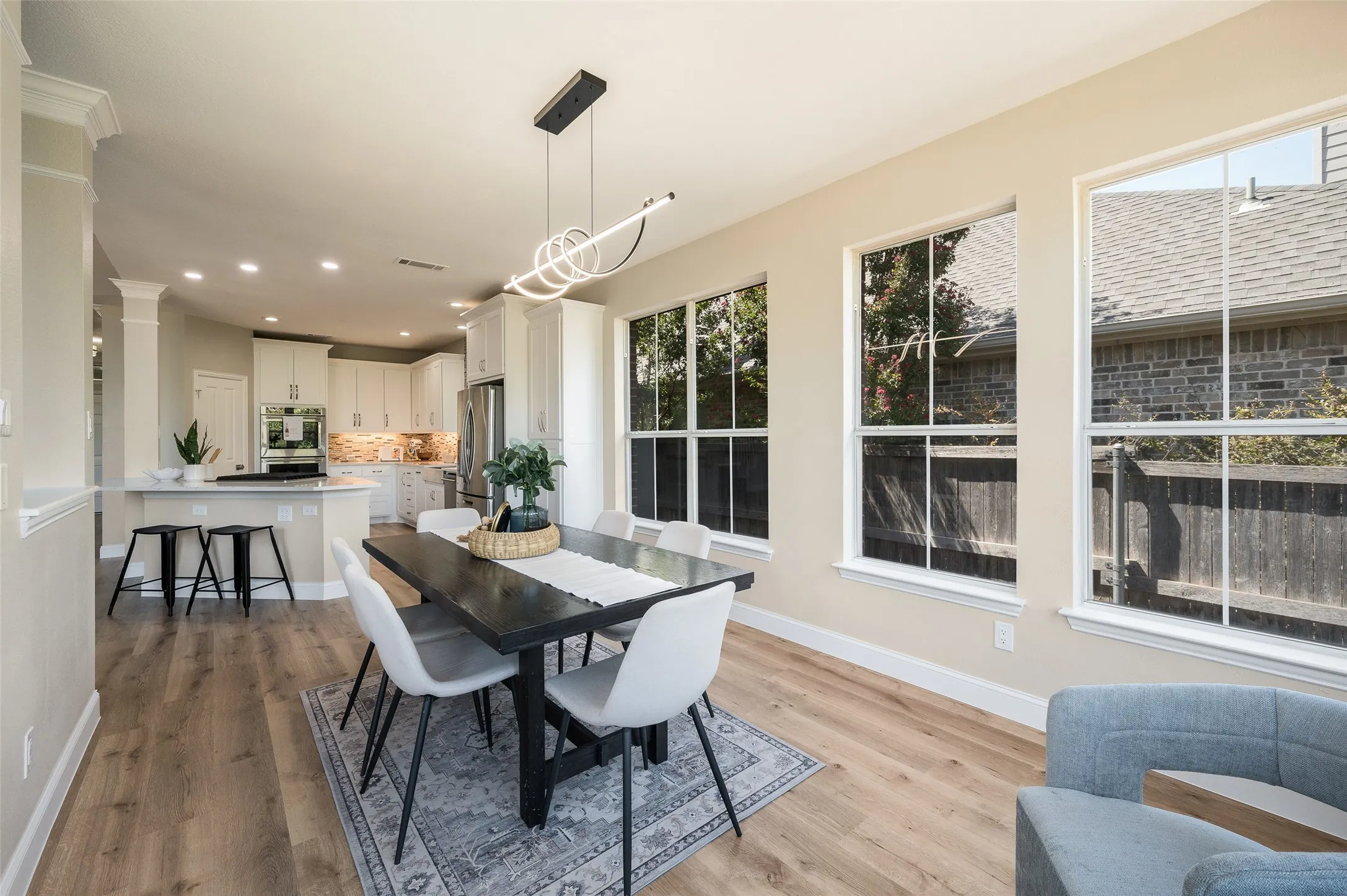 Large dining area with stunning updated modern light fixture.
