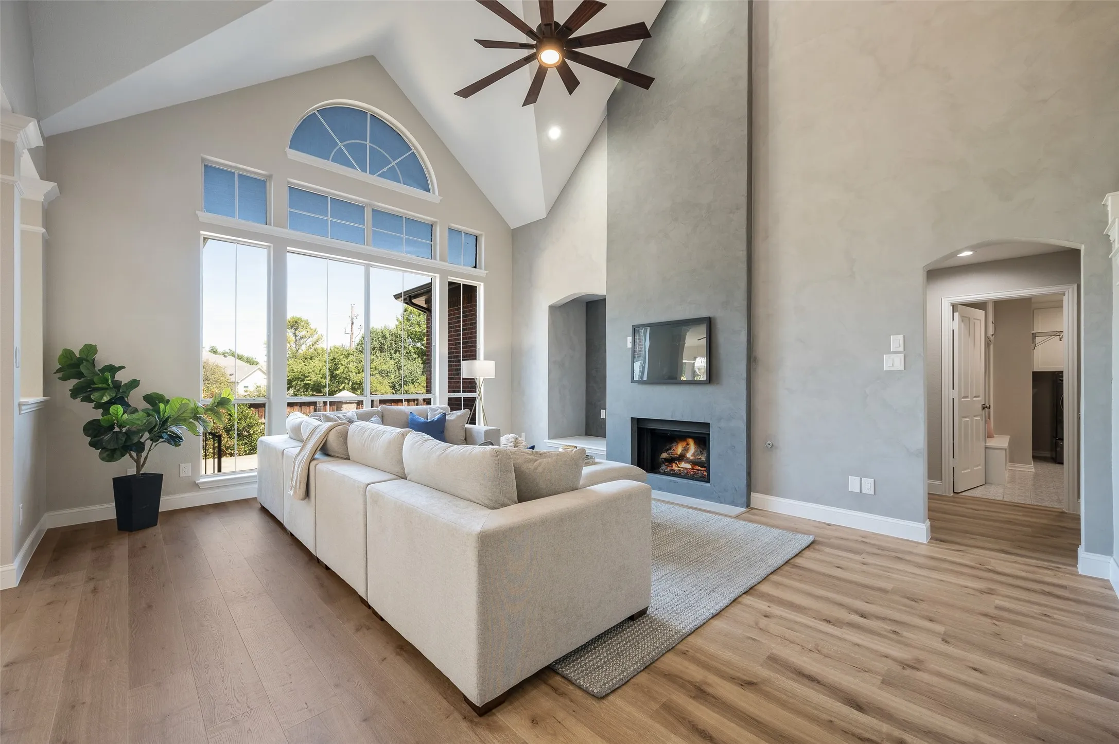Soaring floor to ceiling Limewash and Roman Clay finished gas fireplace.