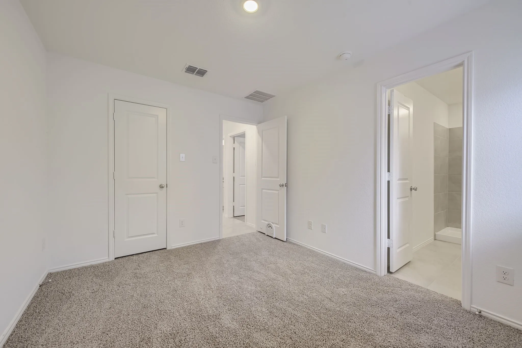 Carpeted flooring, recessed lighting, and white interior doors
