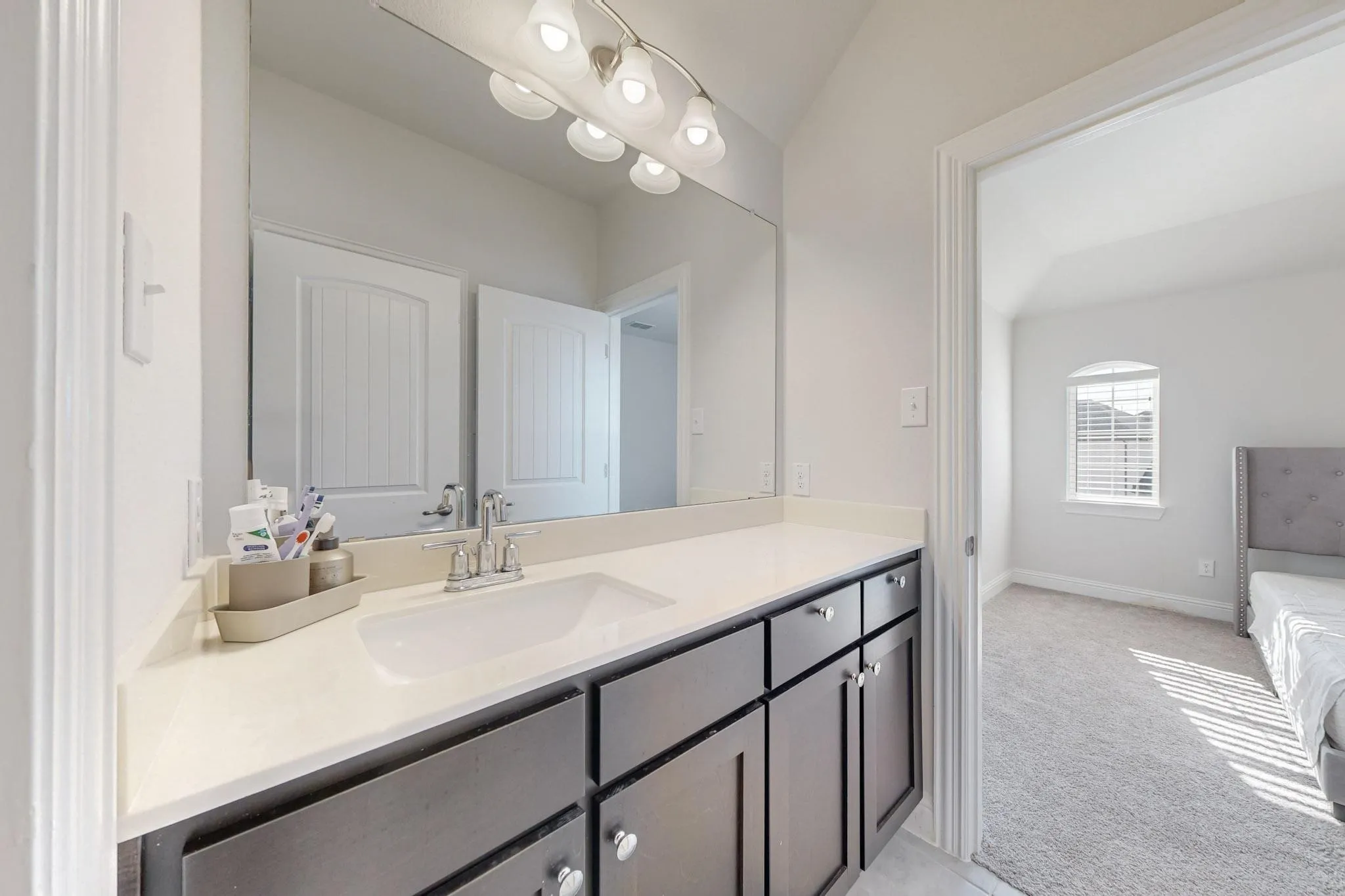 Bathroom featuring vanity and vaulted ceiling