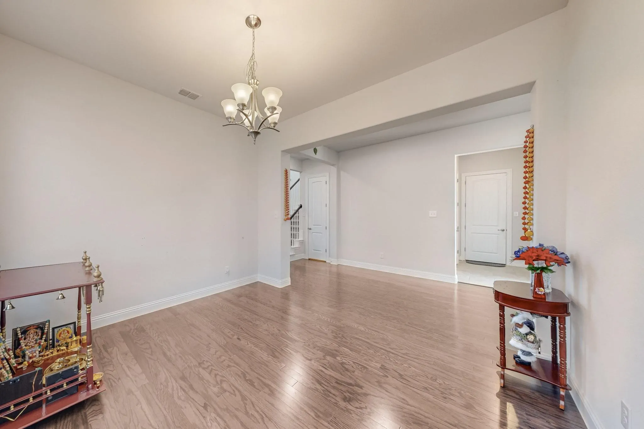 Living room featuring an inviting chandelier and hardwood / wood-style floors