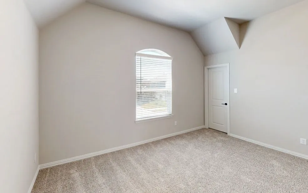 Vaulted ceiling, arched window, carpet flooring, neutral paint, paneled door