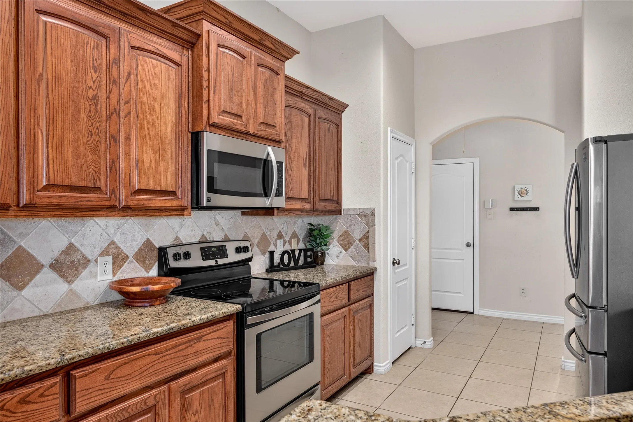 Custom cabinets, granite countertops, tile backsplash and tile flooring