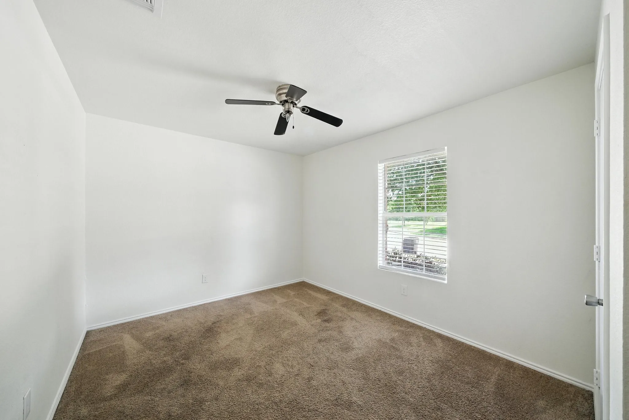 Unfurnished room featuring carpet and ceiling fan