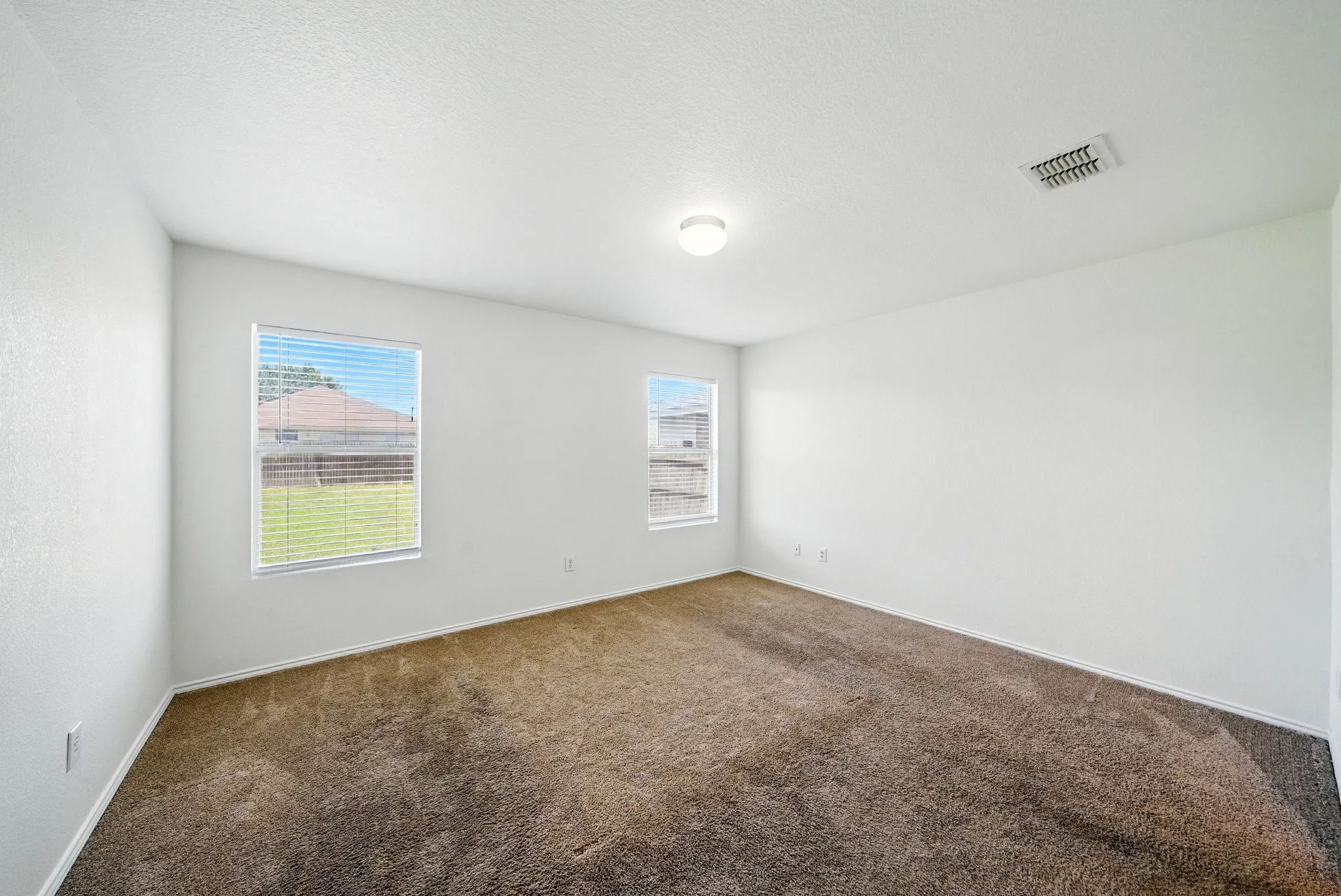 Spare room with carpet floors and plenty of natural light