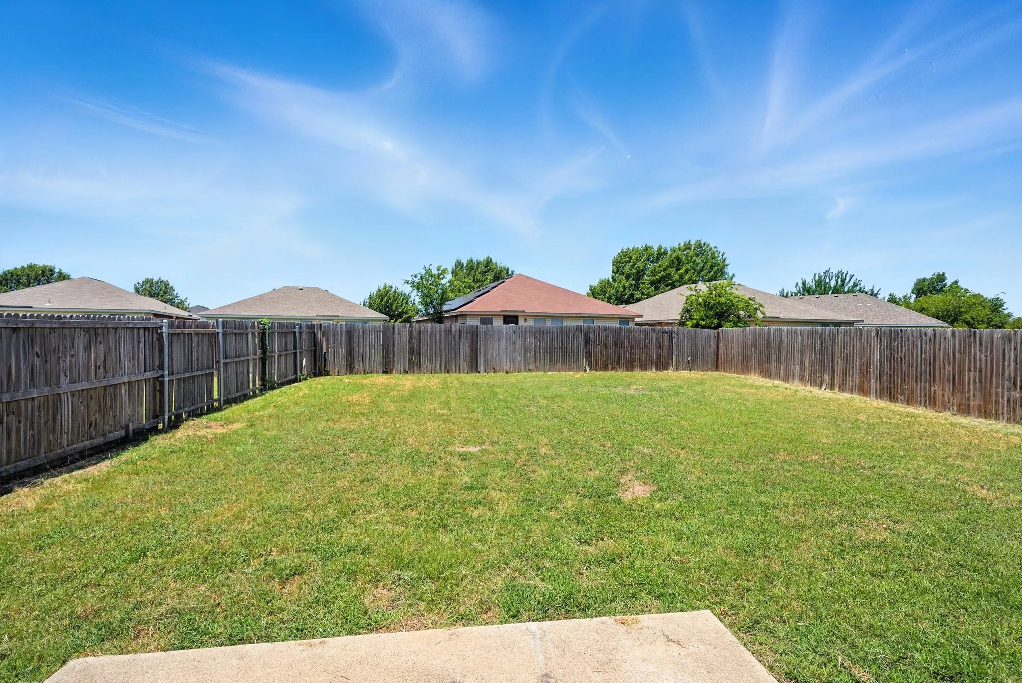 View of fenced backyard