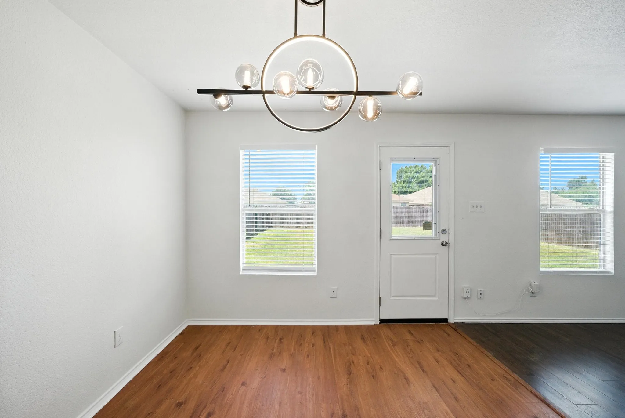 Entryway featuring a chandelier, wood finished floors, and healthy amount of natural light