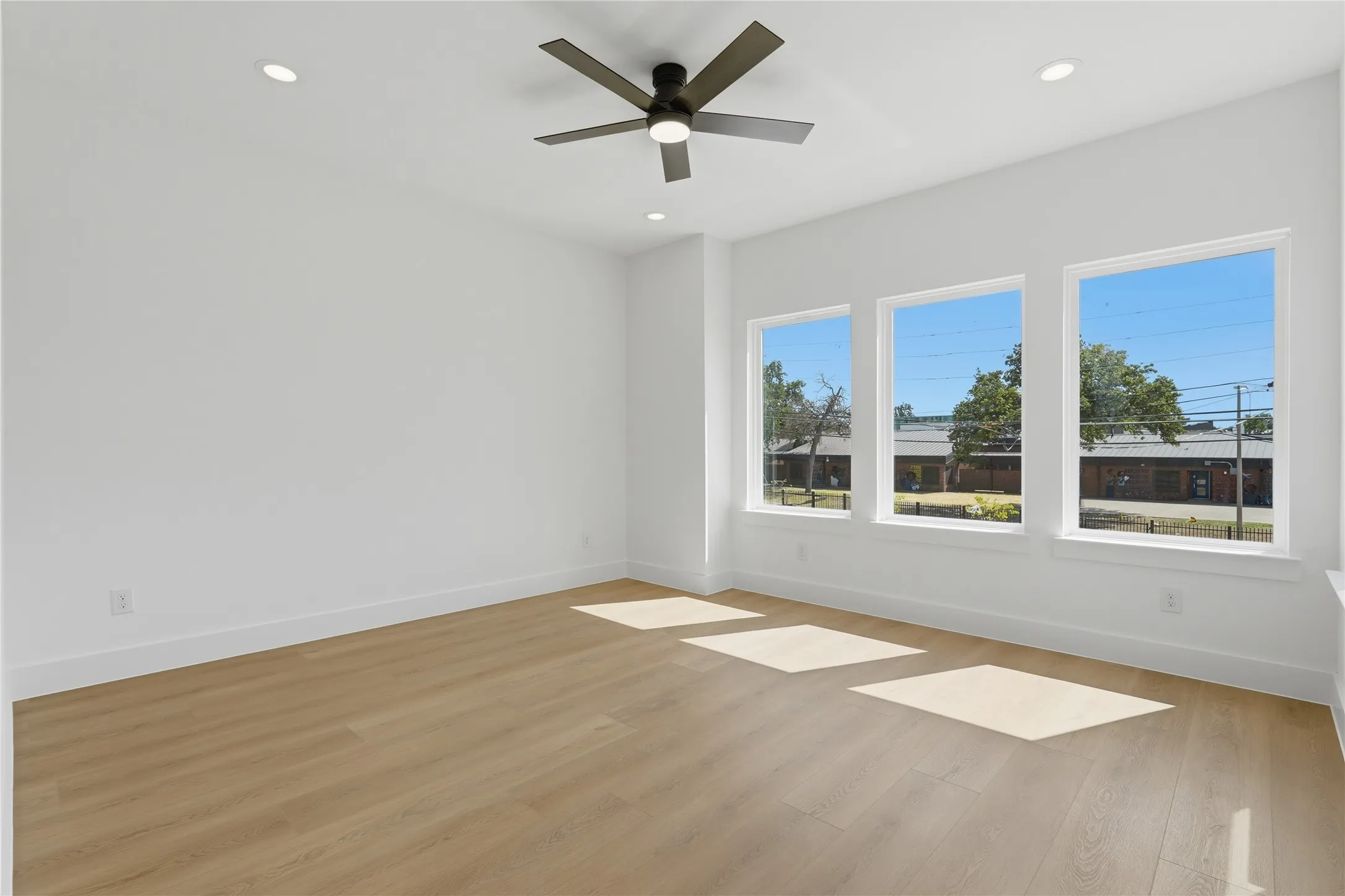 Wood-finish flooring, recessed lighting, and a ceiling fan with integrated lighting