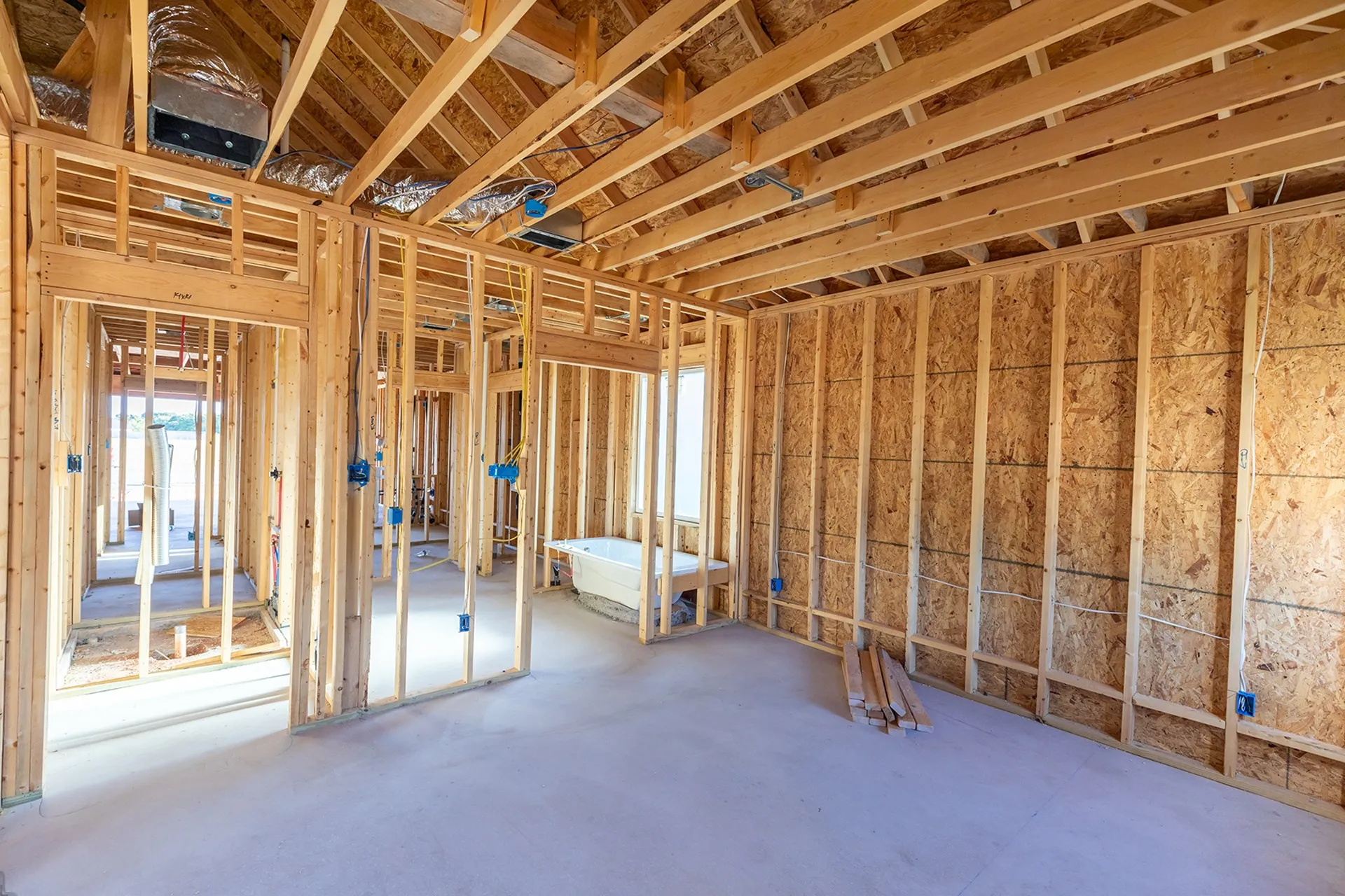 Unfinished interior framing with exposed ceiling joists and wall studs