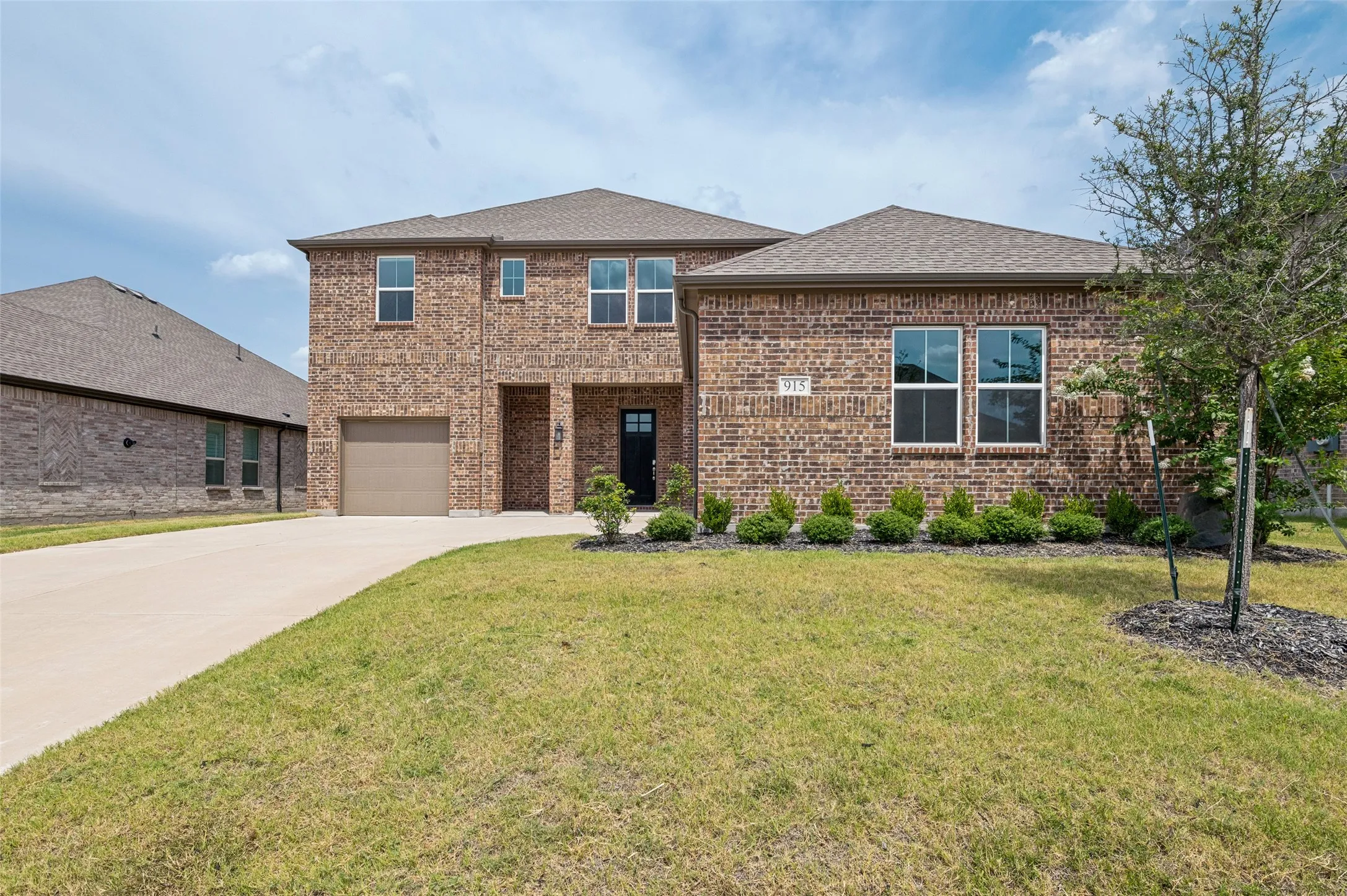 Brick exterior with a gabled roof and attached garage