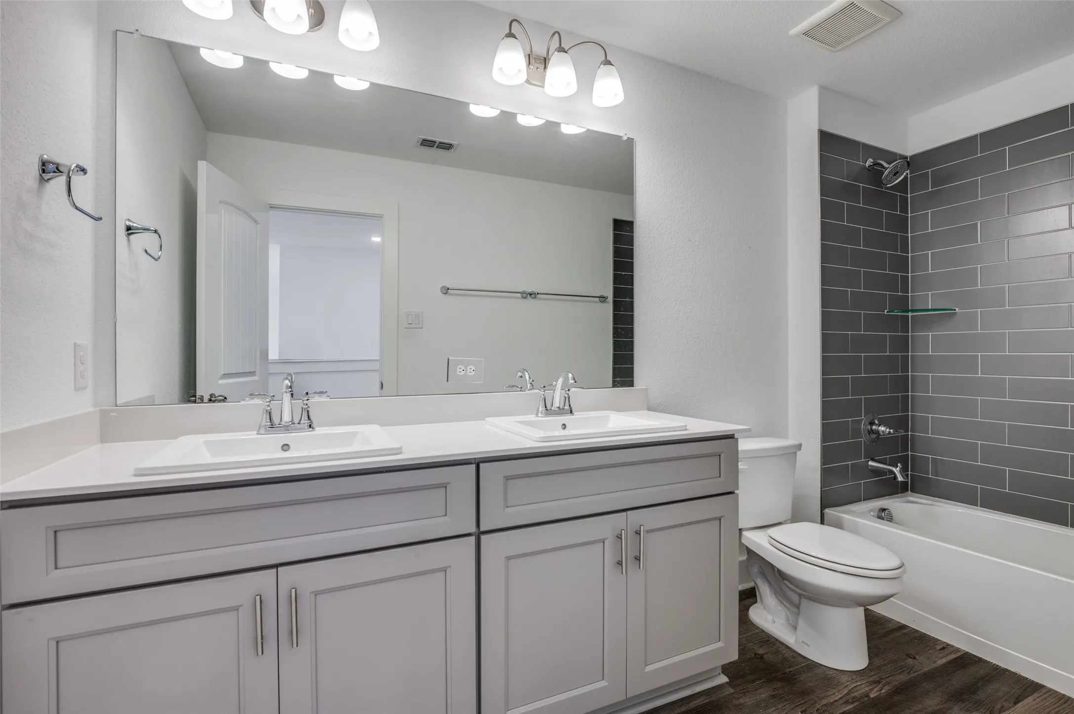 Dual vanity with white undermount sinks and light-colored countertops