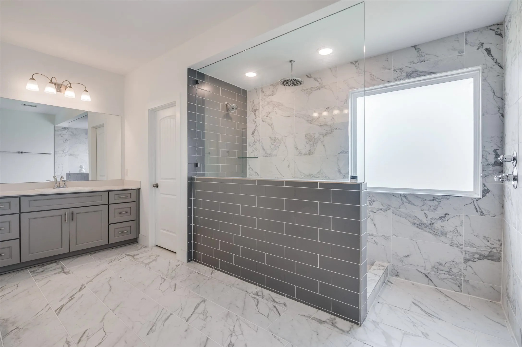 Dual-sink vanity with gray cabinetry, white countertop, and polished chrome fixtures
