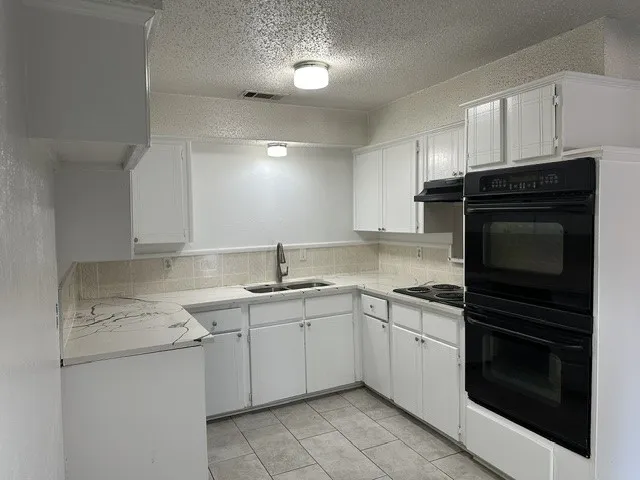 Kitchen featuring double ovens