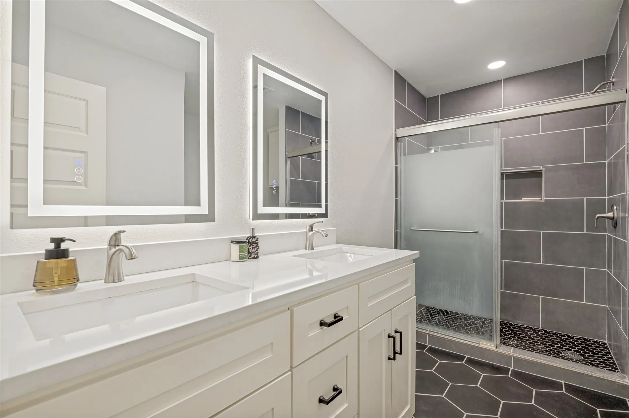 ensuite to the primary bedroom offers dual sinks, walk in shower and extra storage space