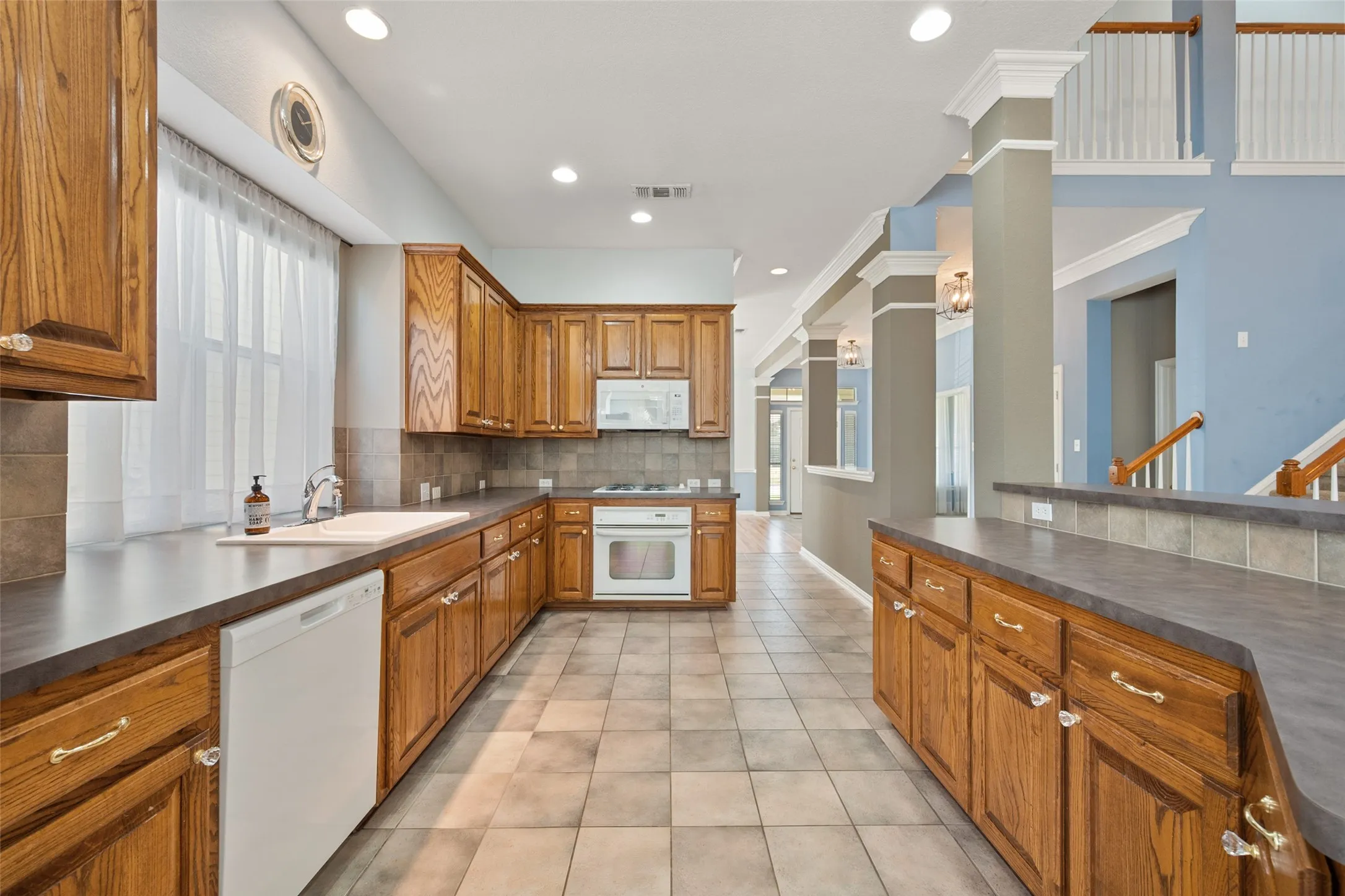 Kitchen features a ton of custom cabinets, gas stove, window over the sink and a recently purchased referigerator that stays with the home