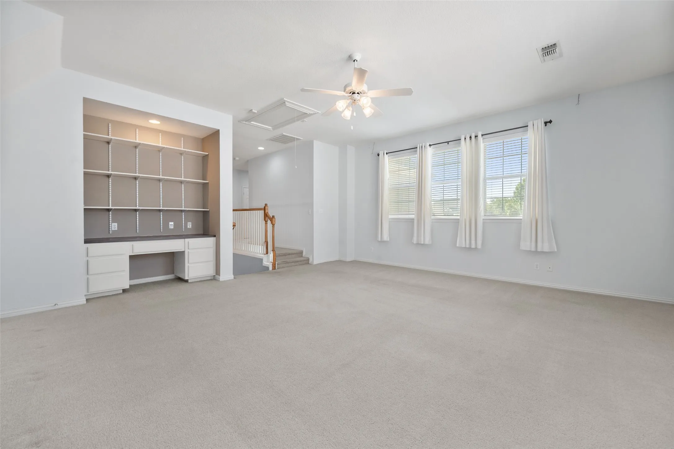 Upstairs gameroom has a built in desk area