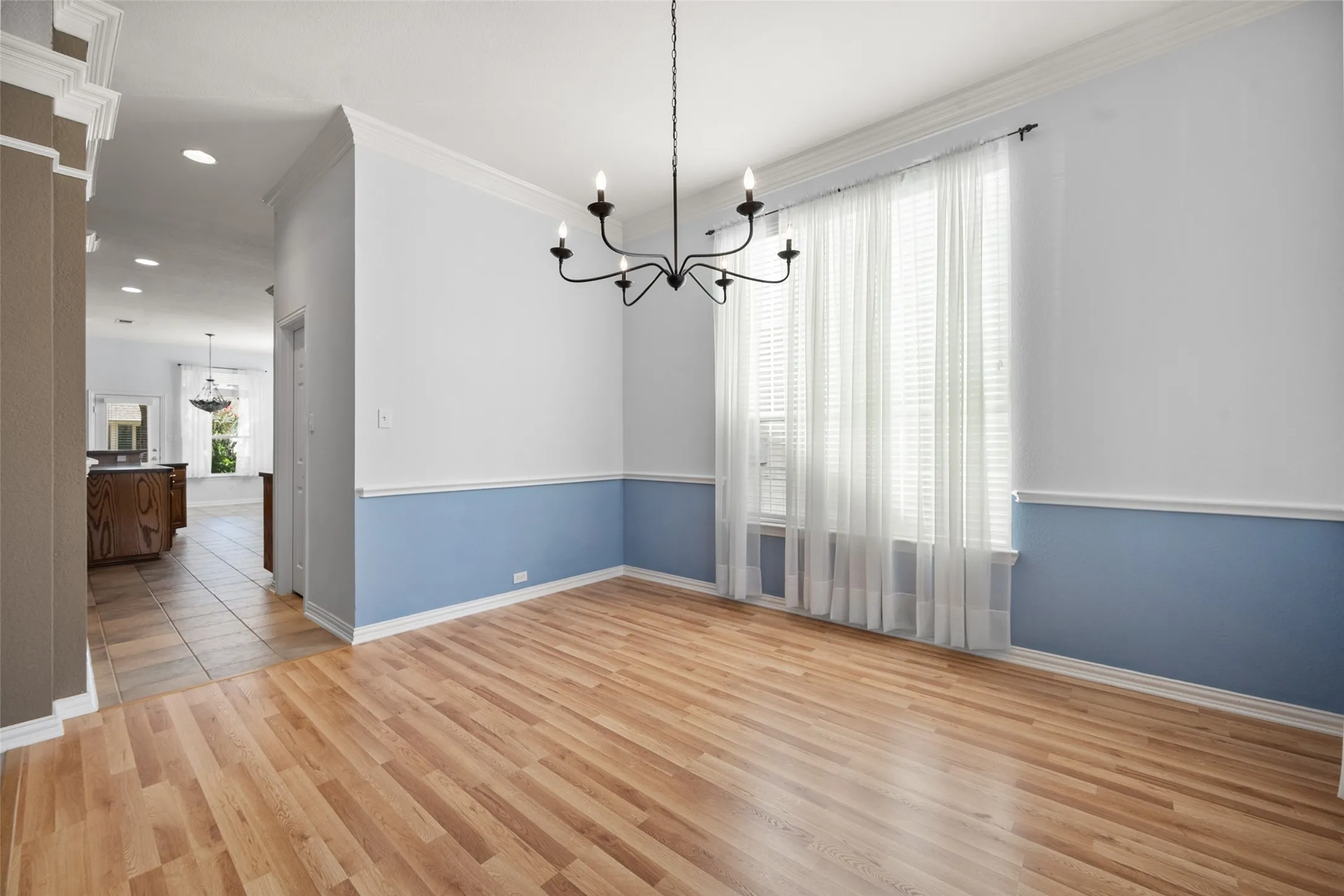The formal dining room has pretty wood floors and an updated light fixture