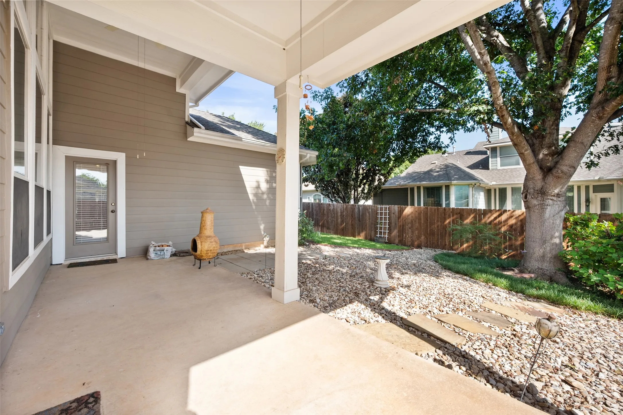 Backyard has a big covered patio with 2 ceiling fans - perfect space to cook out, sit with the coffee and enjoy the nature