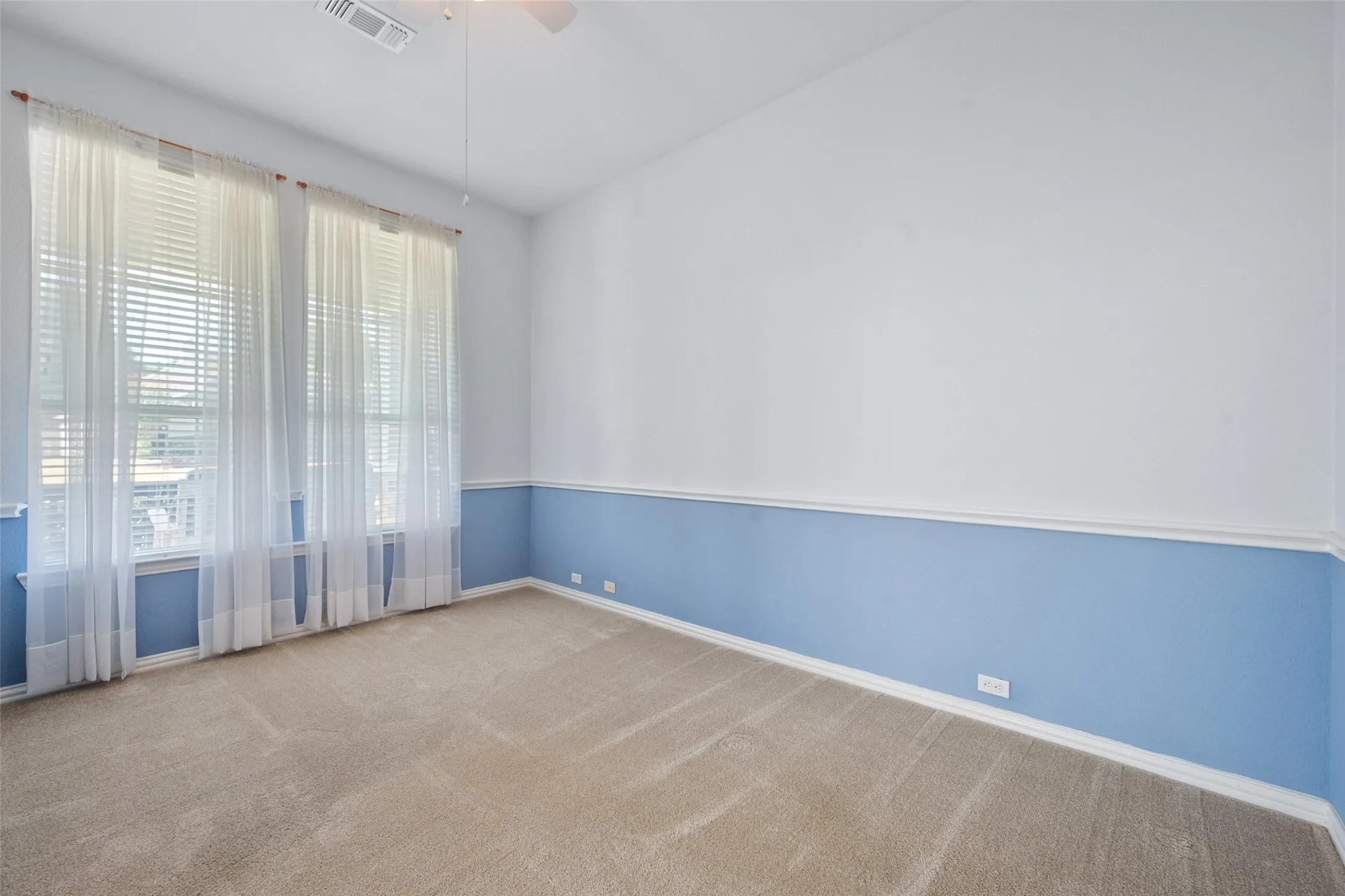 Another view of the large windows facing the front of the home in the office space
