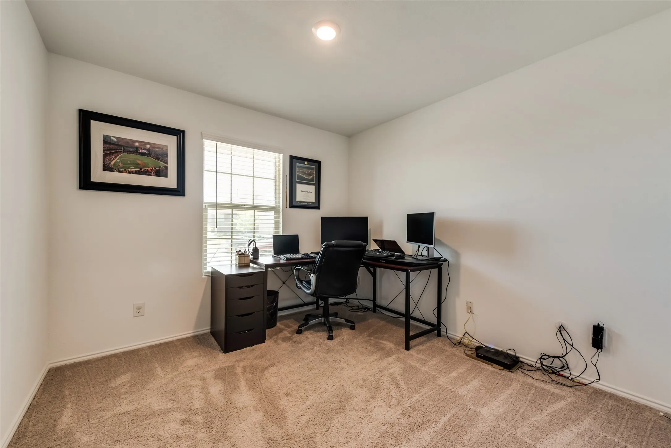 Recessed ceiling lighting, neutral-toned walls, textured carpeting, and a window with blinds