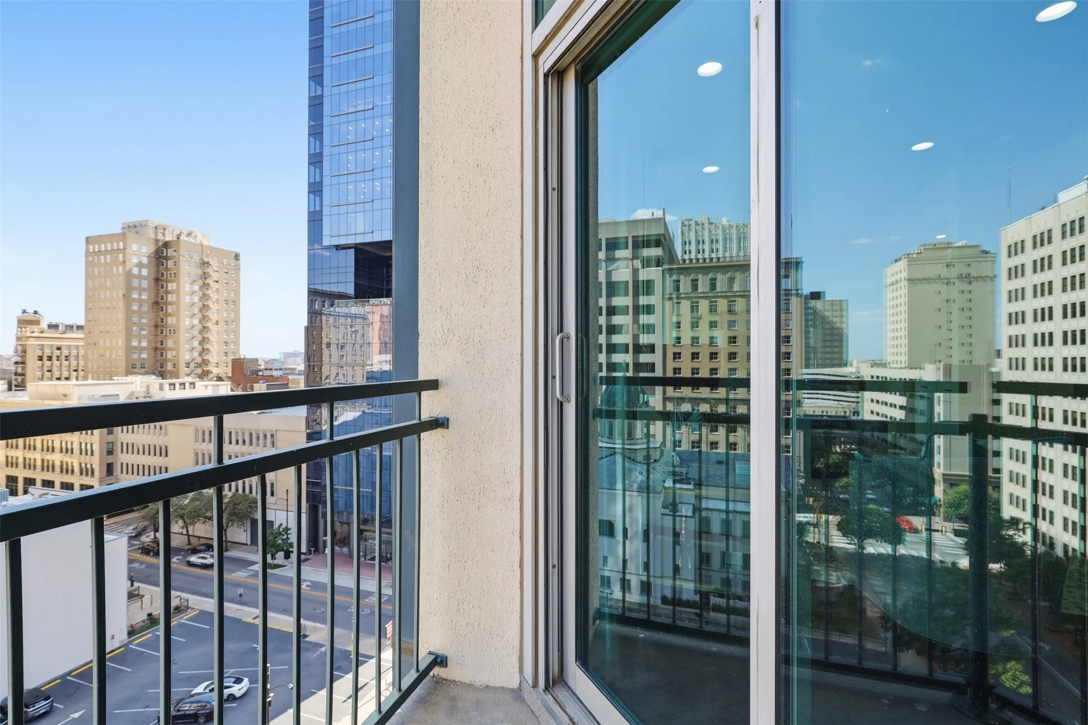 Balcony with metal railing and city skyline