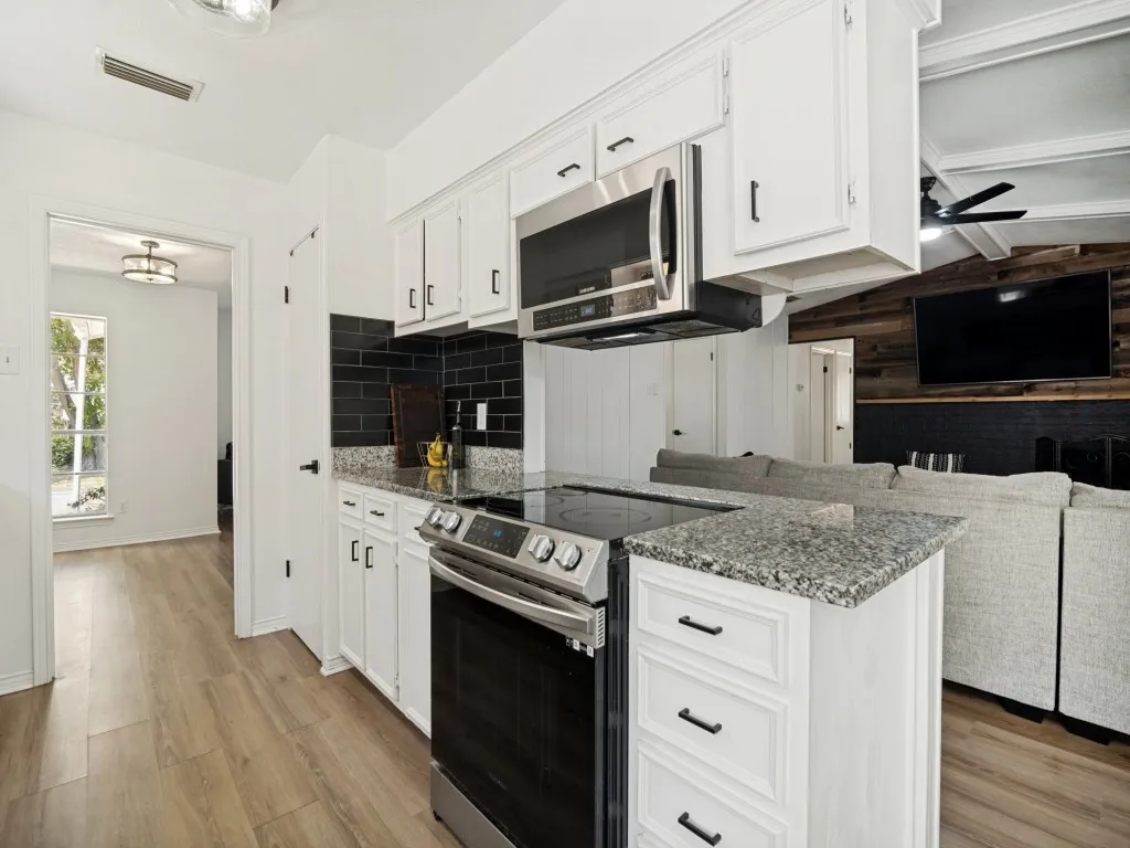 Kitchen features granite tops, updated back splash, built in microwave and more!