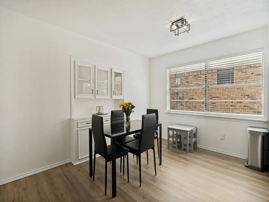 Bright breakfast area with built in cabinets.