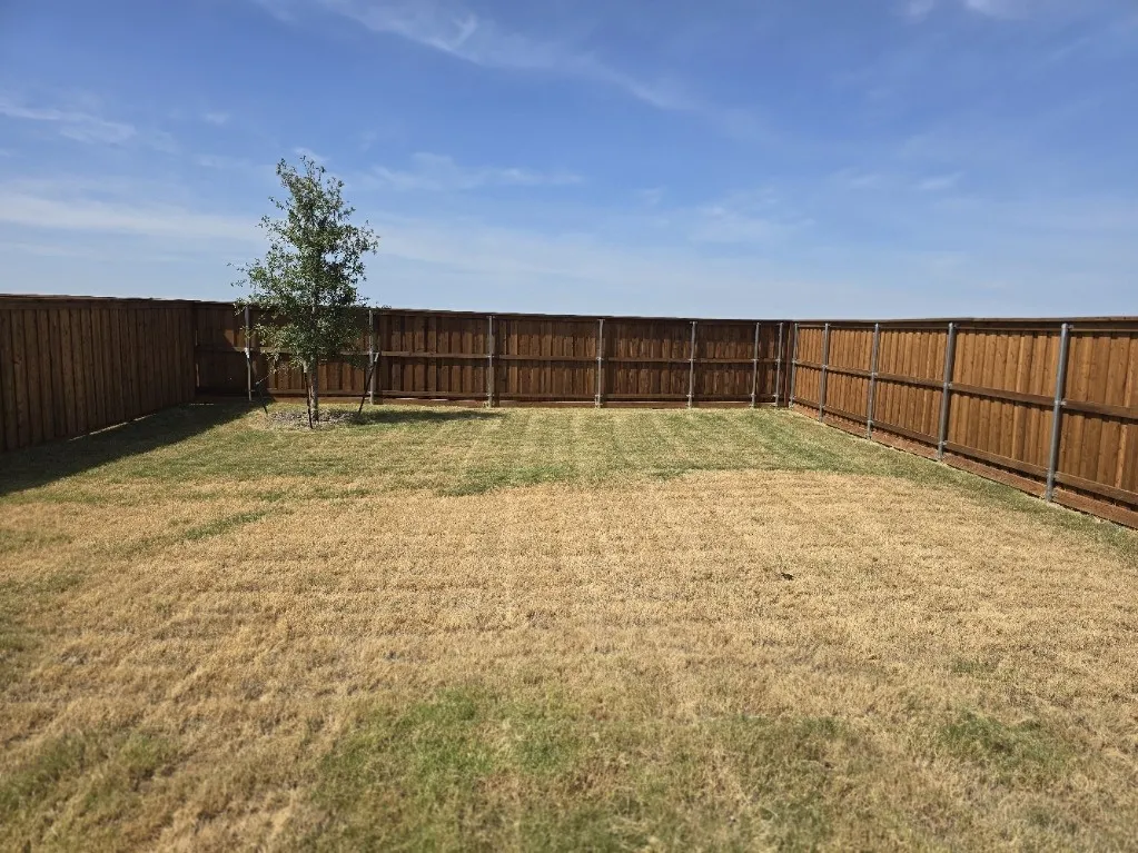 Expansive backyard featuring a privacy, board-on-board fence with ample open space. You do not see your neighbors !